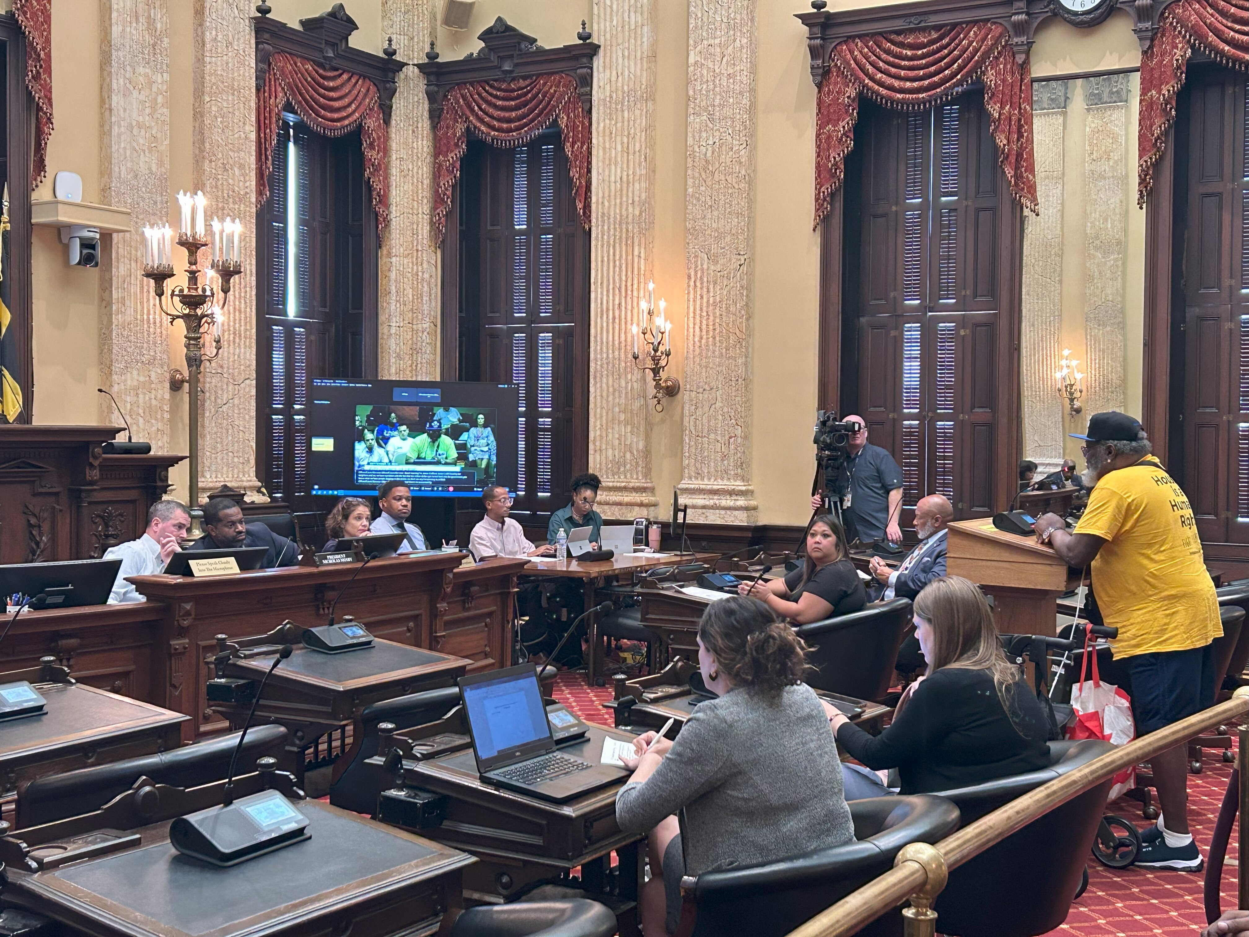 James Crawford Jr. of Housing Our Neighbors addresses the Baltimore City Council on Sept. 12, 2023, as Mayor’s Office of Homeless Services director Irene Agustin looks on.