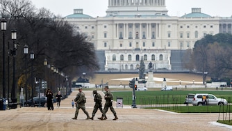 National Guard patrol on the National Mall near the U.S. Capitol, Wednesday, Nov. 26, 2025, in Washington. (AP Photo/Rahmat Gul)