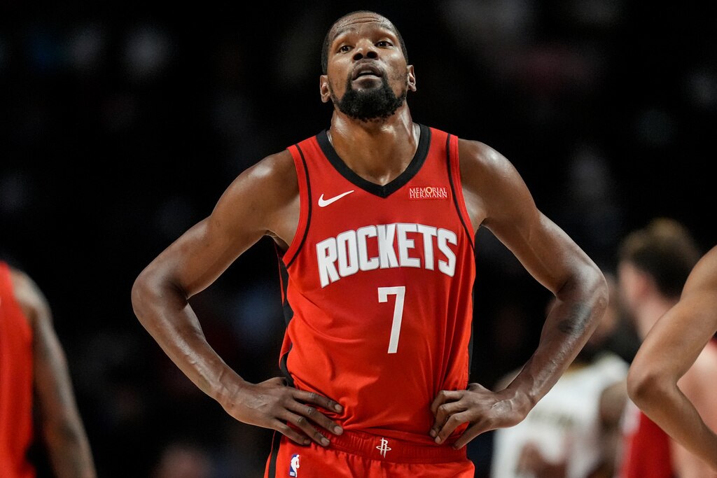 Houston Rockets forward Kevin Durant, in his Rockets uniform, with his hands resting on his hips during a game.