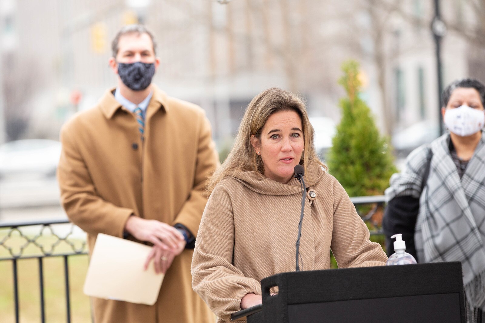 Baltimore County Inspector General Kelly Madigan speaks during a press conference Dec. 21, 2020. Baltimore County Executive Johnny Olszewski Jr. and Baltimore County Administrative Officer Stacy Rodgers stand behind her.