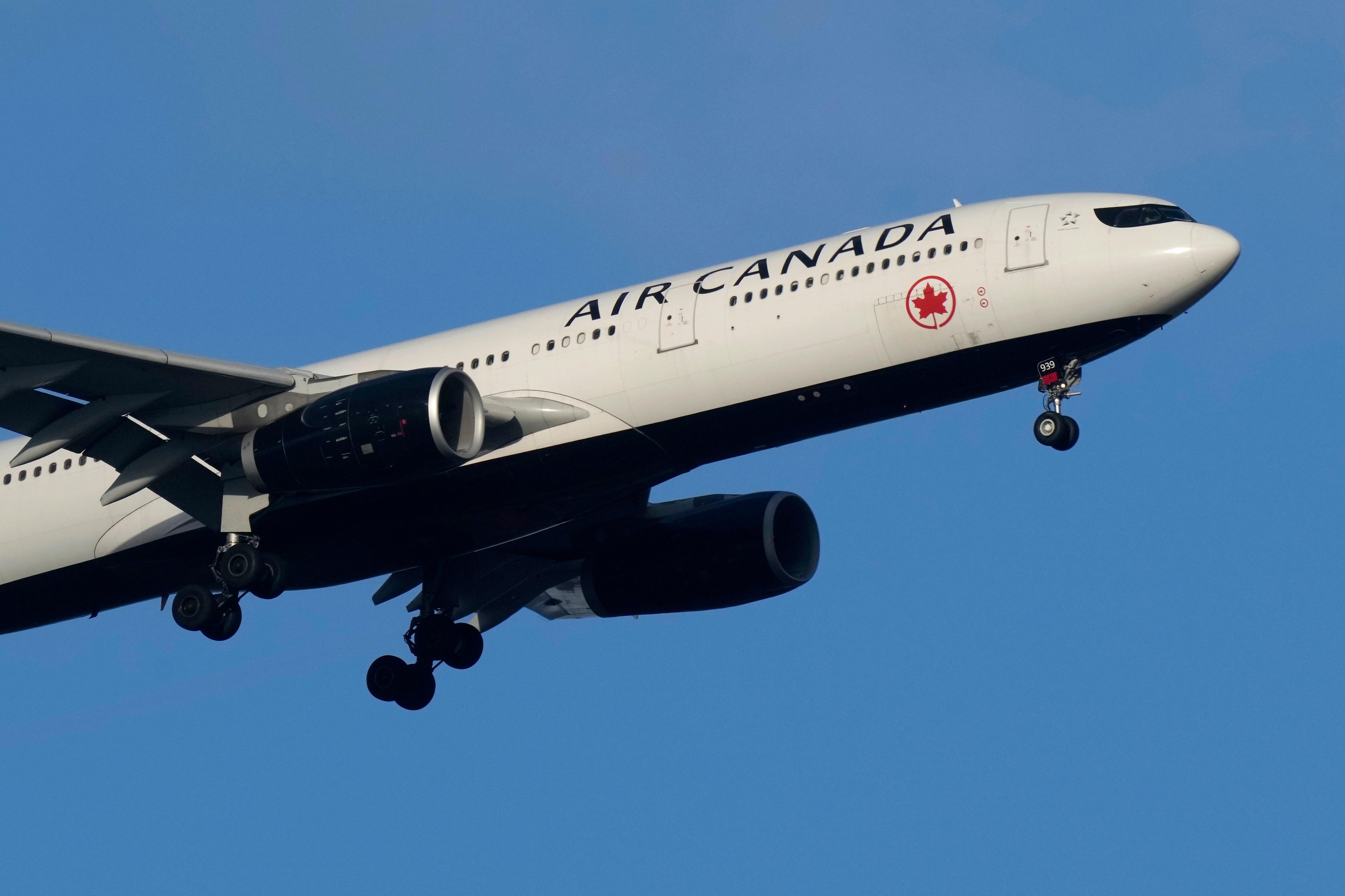 An Air Canada Airbus A330 approaches for landing in Lisbon, Saturday, Sept. 2, 2023. (AP Photo/Armando Franca)