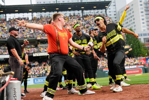 Members of The Firefighters pump up the crowd ahead of a Banana Ball game against the Savannah Bananas at Oriole Park at Camden Yards in Baltimore, Md. on Friday, August 1, 2025. It’s the first of two games to be played at Camden Yards this weekend.