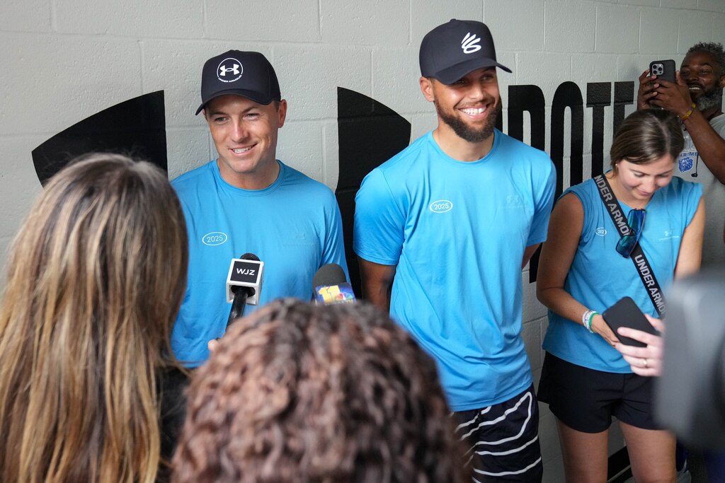 Professional golfer Jordan Spieth, left, and NBA superstar Stephen Curry take questions from reporters during ‘Armour Day’ at Carver Vocational Technical High School in Baltimore, Md., on Monday, Sept. 15, 2025.