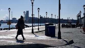A person walks in Fells Point, Baltimore, on Wednesday, January 22, 2025. Below freezing conditions persisted in Maryland Wednesday morning, accompanied by wind gusts making it feel close to zero degrees in parts of the state. The extreme cold warning for western Maryland and the cold weather advisory for the rest of the state — including Baltimore City and Baltimore, Howard, Anne Arundel, Harford and Carroll counties — remain in effect until Thursday morning at 10 a.m.