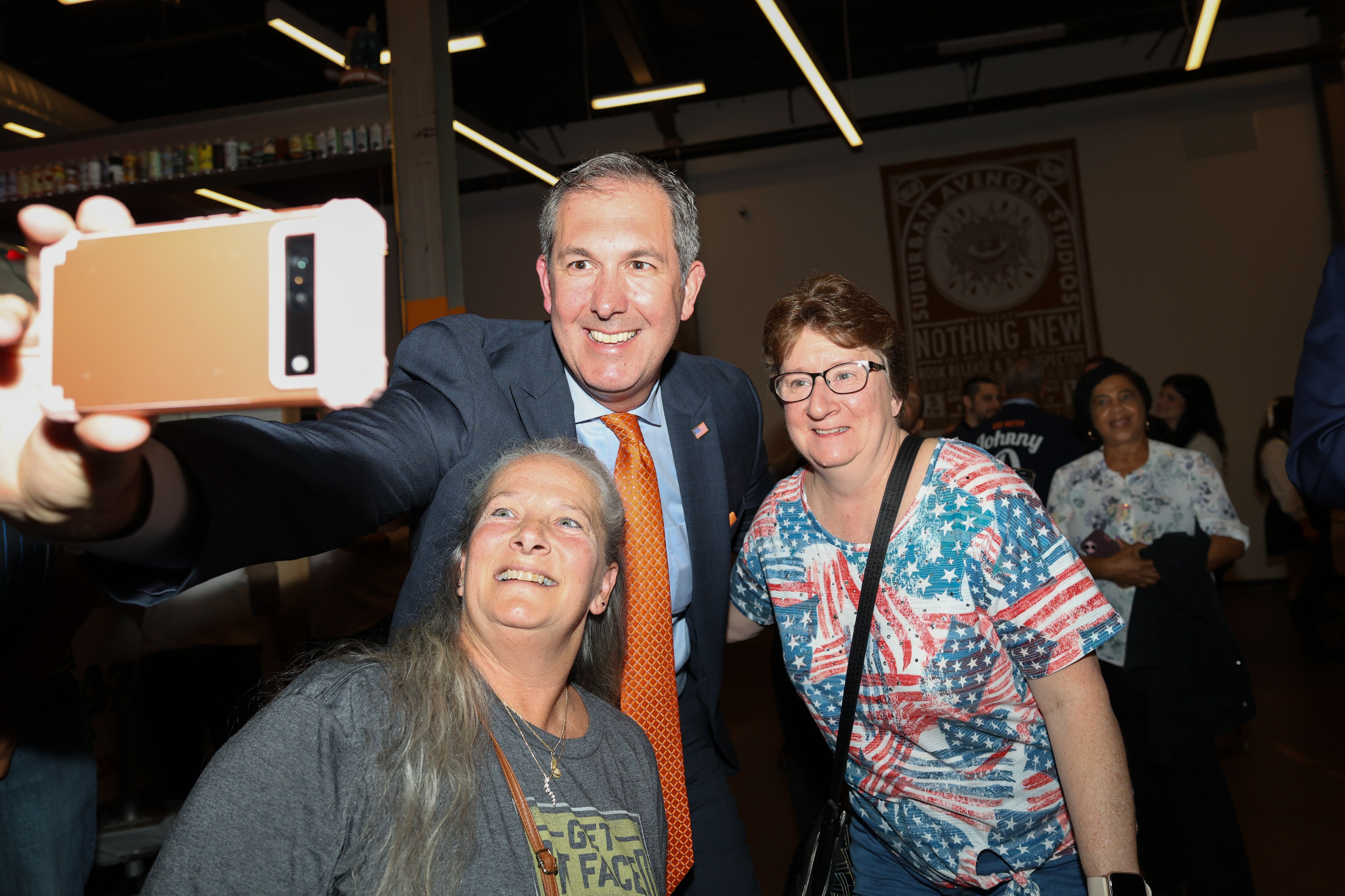 Johnny Olszewski takes a selfie with supporters during his election night watch party at Union Craft Brewing in Baltimore, MD on Nov. 5, 2024.