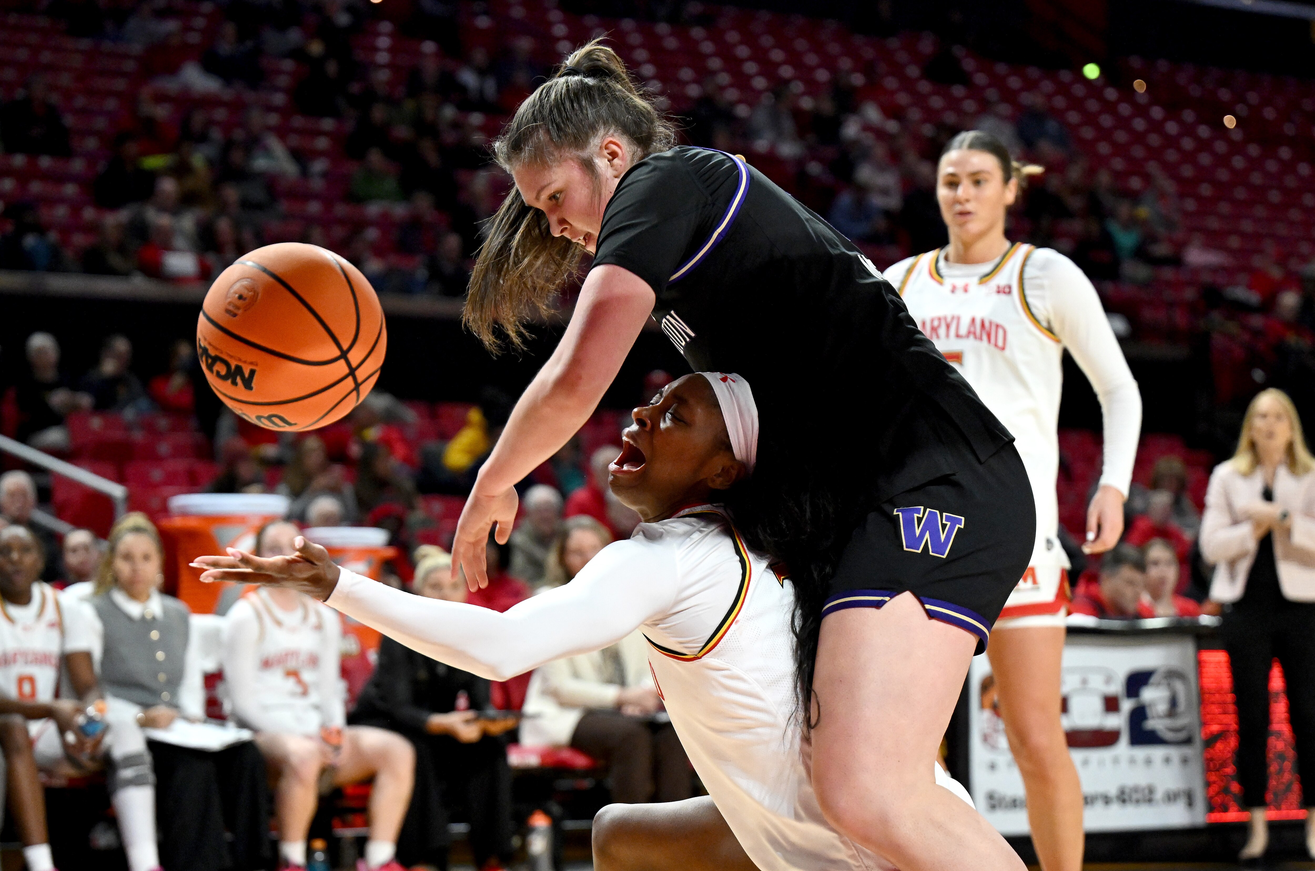 Oluchi Okananwa of Maryland draws a foul on Brynn McGaughy of Washington during the third quarter Wednesday night.