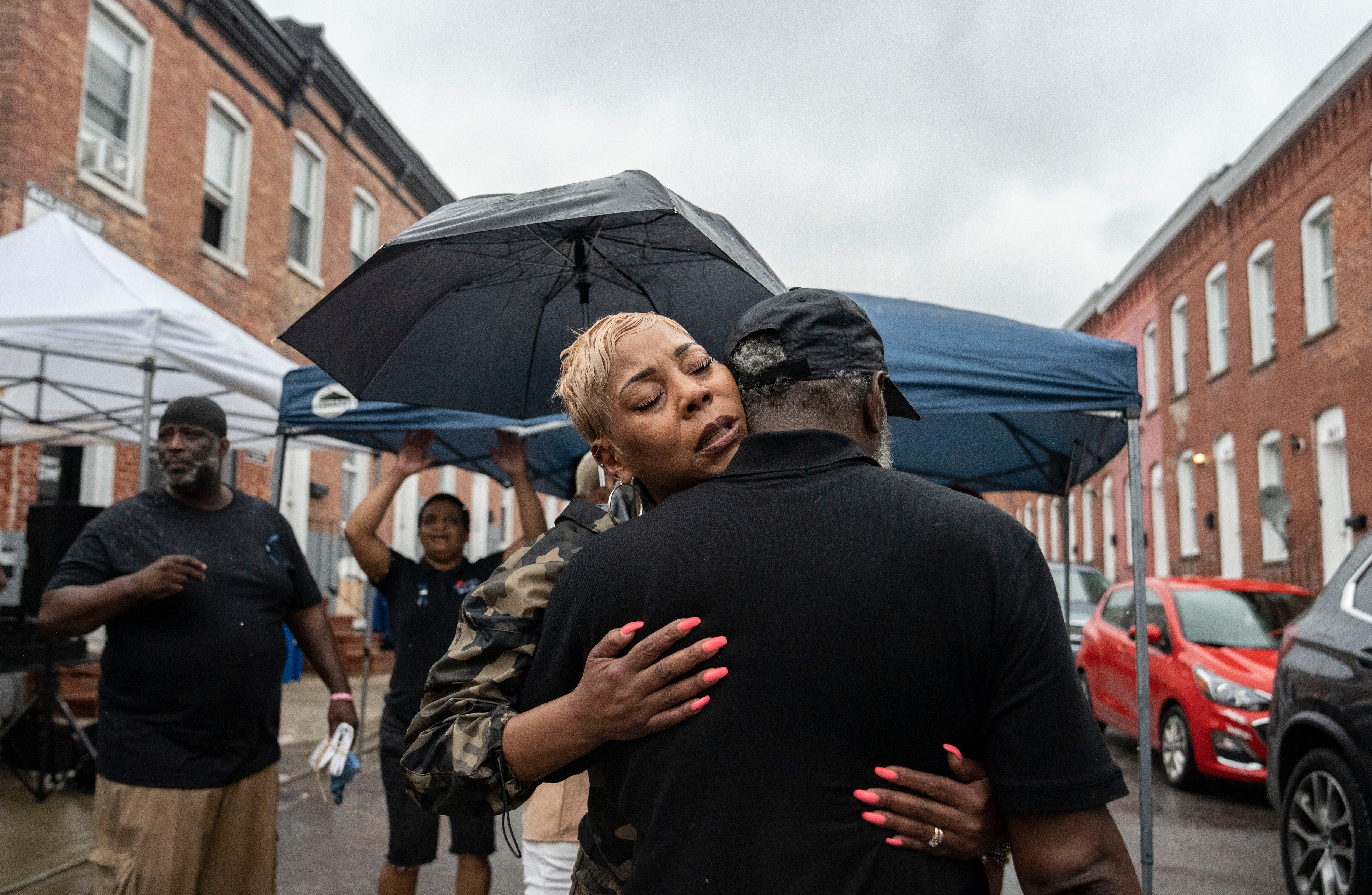 Donna Bruce hugs her husband Dwayne after a street was renamed Devon Wellington's Way, after their son who passed away from an overdose.