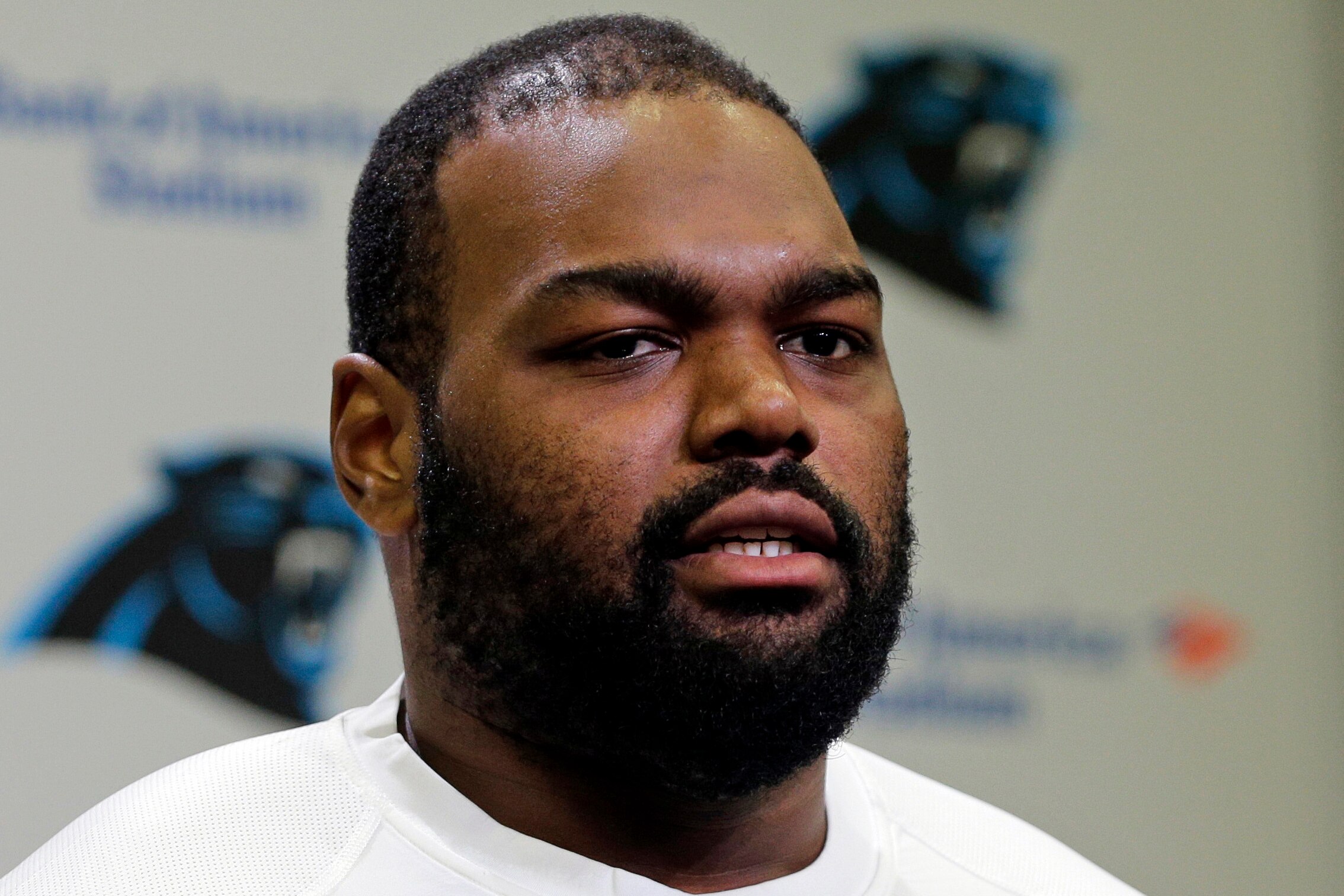 FILE - Carolina Panthers’ Michael Oher speaks to the media during the first day of their NFL football offseason conditioning program in Charlotte, N.C., April 20, 2015. Oher, the former NFL tackle known for the movie “The Blind Side,” filed a petition Monday, Aug. 14, 2023, in a Tennessee probate court accusing Sean and Leigh Anne Tuohy of lying to him by having him sign papers making them his conservators rather than his adoptive parents nearly two decades ago.