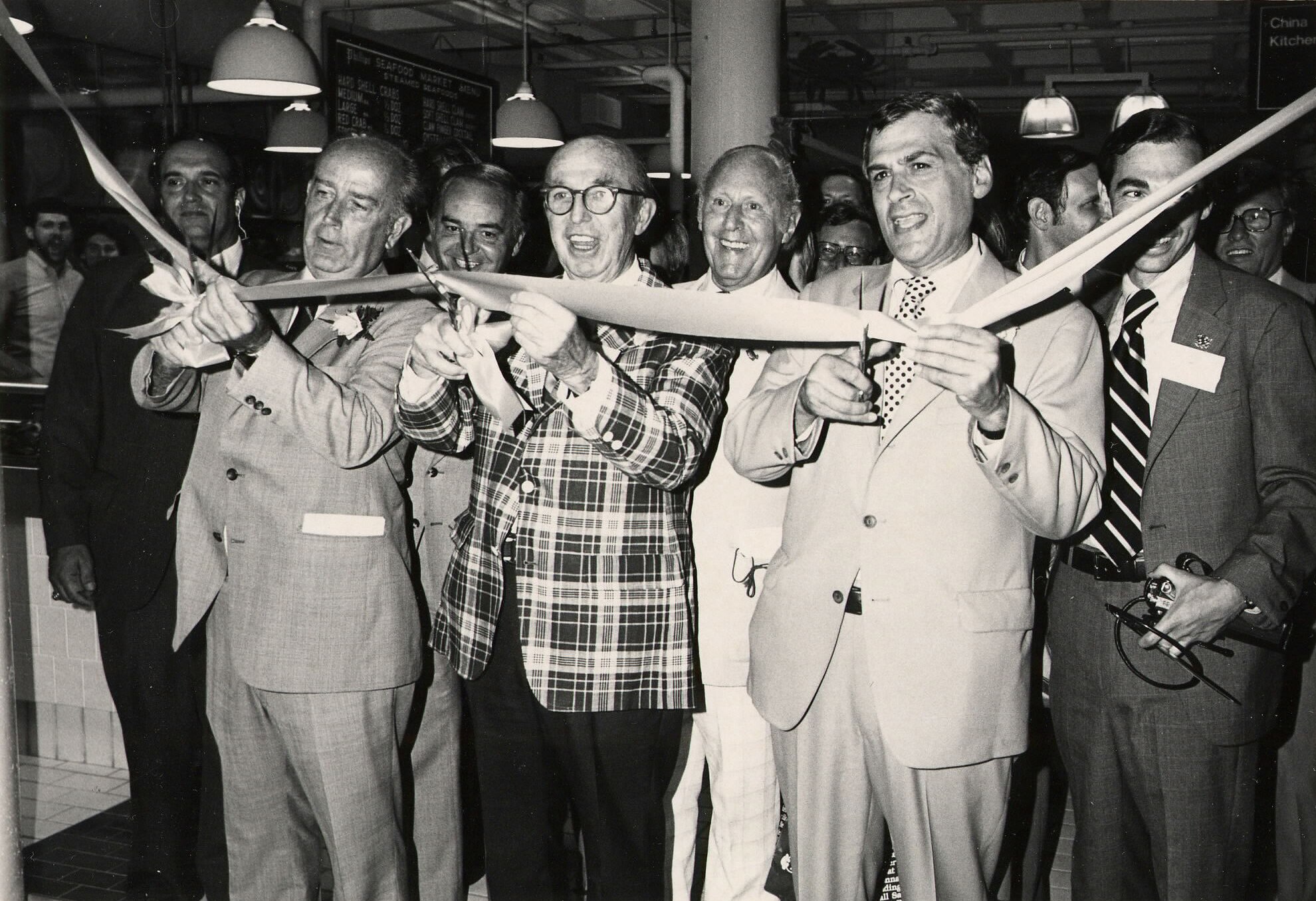 Then-Mayor William Donald Schaefer, left, and James Rouse, center, cut the ceremonial ribbon at the opening of Harborplace in Baltimore on July 3, 1980.
