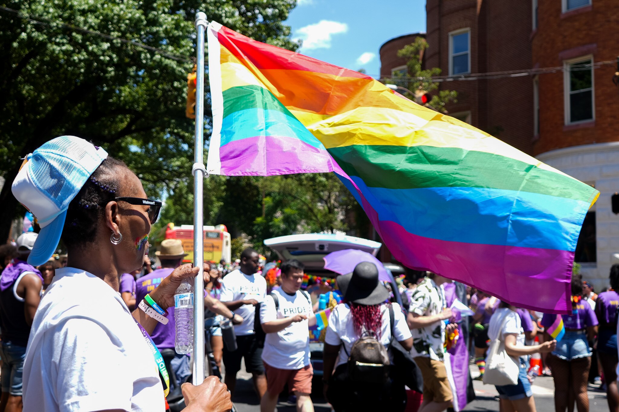 A parade participant is photographed clutching on to a rainbow flag at Baltimore’s Pride Parade held on June 15, 2024.