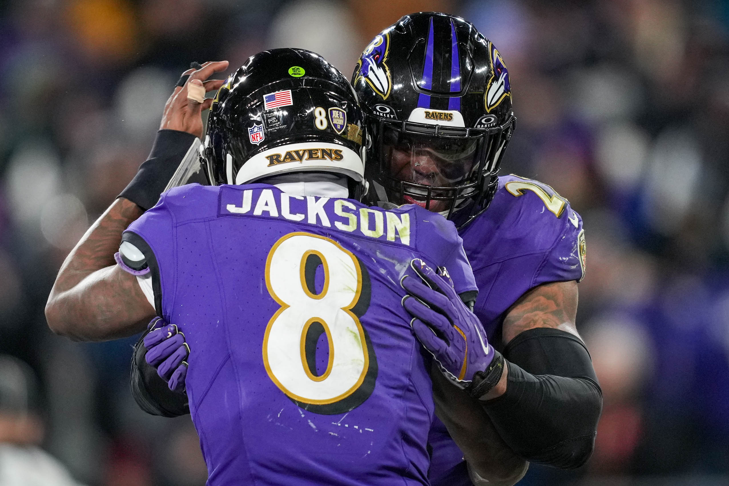 Baltimore Ravens quarterback Lamar Jackson (8) hugs running back Derrick Henry (22) after he rushed for a touchdown against the Cleveland Browns.