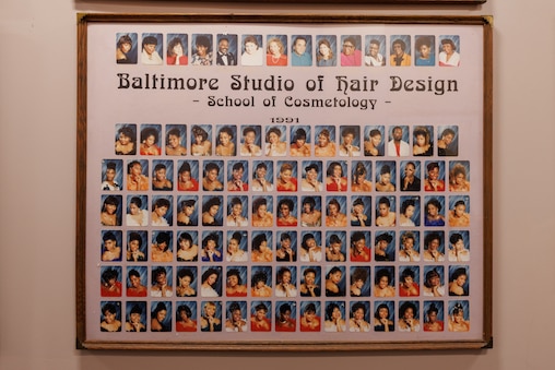 The hallways of the Baltimore Studio of Hair Design are lined with photos of former classes.