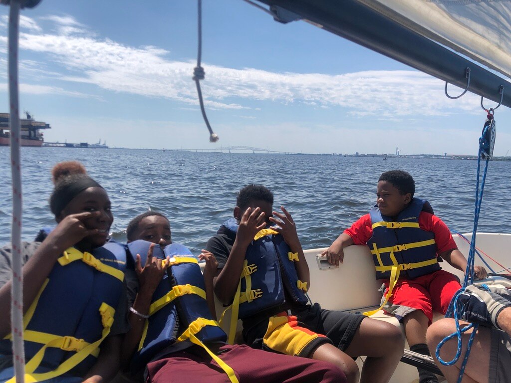 Campers with the Downtown Sailing Center cheer when they reach the Key Bridge.