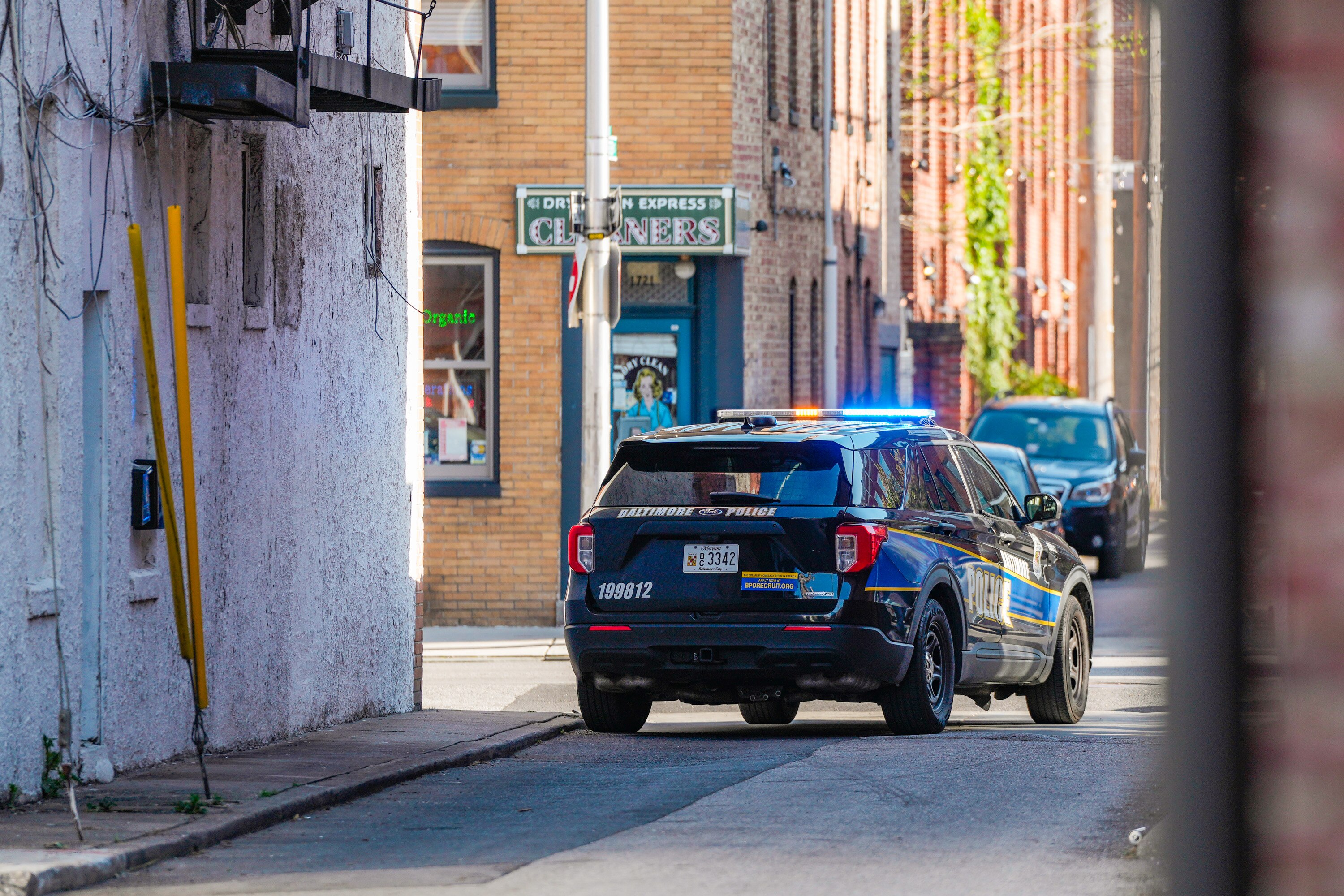 A Baltimore Police vehicle blocks off Regester Street in Fells Point on April 14, 2024.