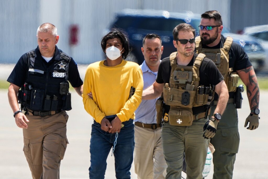 Law enforcement agents escort 23-year-old Victor Martinez-Hernandez from an airplane at Martin State Airport after his extradition from Oklahoma, June 20, 2024. Martinez-Hernandez is charged with raping and killing Rachel Morin of Harford County.