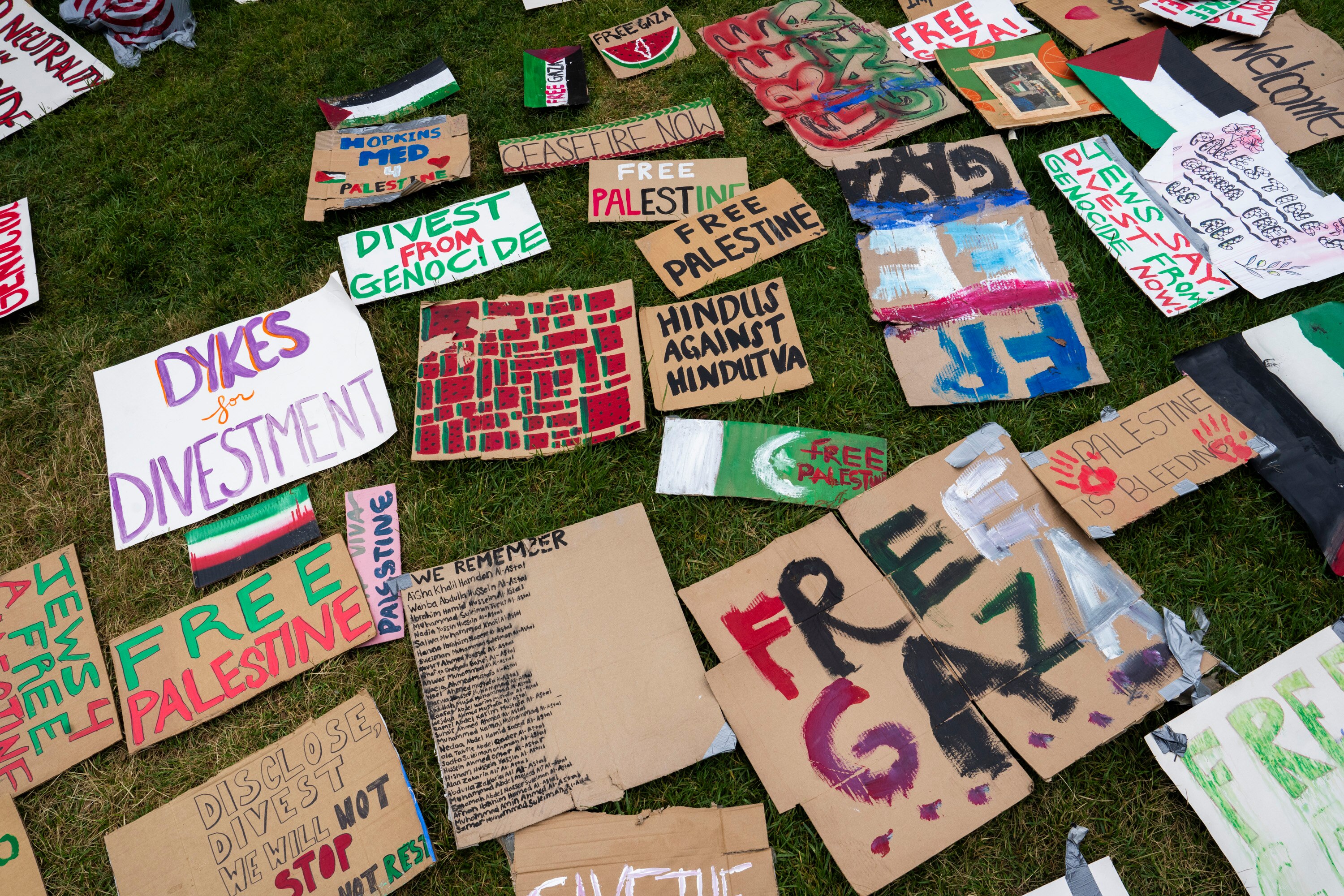 Signs at Johns Hopkins University amid protests of the war in Gaza and calls for university divestment in response to Israeli government actions.