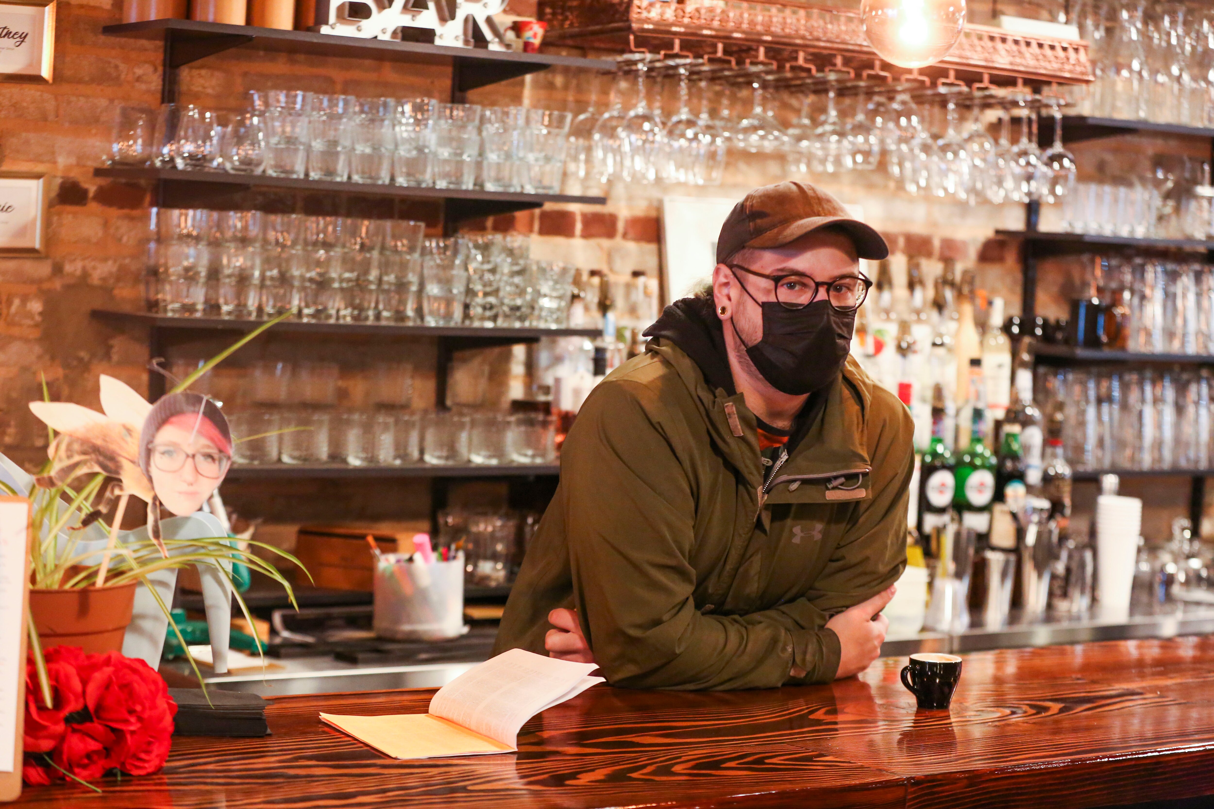 Andi Scotti, 34, tends the bar at Red Emma’s. The worker-owners are in their final stages of opening their new location at 3128 Greenmount. The main floor has the bar, food and seating while the downstairs has the book store with a variety of books organized by subject matter that Red Emma’s is known for.