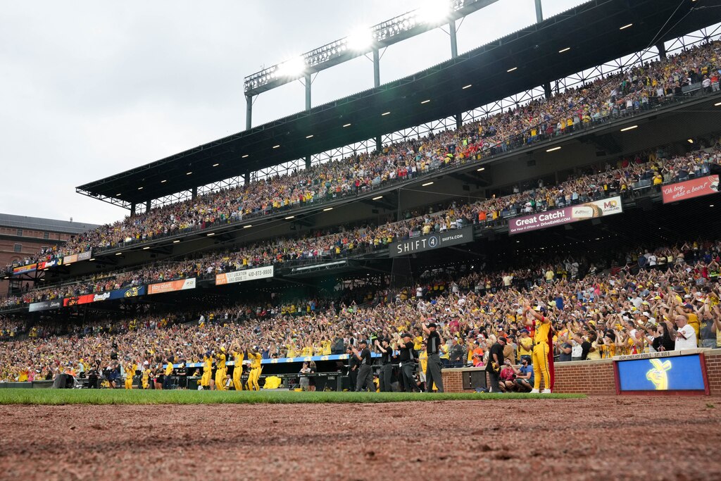 A sold out crowd dances in their seats with the Savannah Bananas during the pregame show ahead of a Banana Ball game against The Firefighters at Oriole Park at Camden Yards in Baltimore, Md. on Friday, August 1, 2025. It’s the first of two games to be played at Camden Yards this weekend.