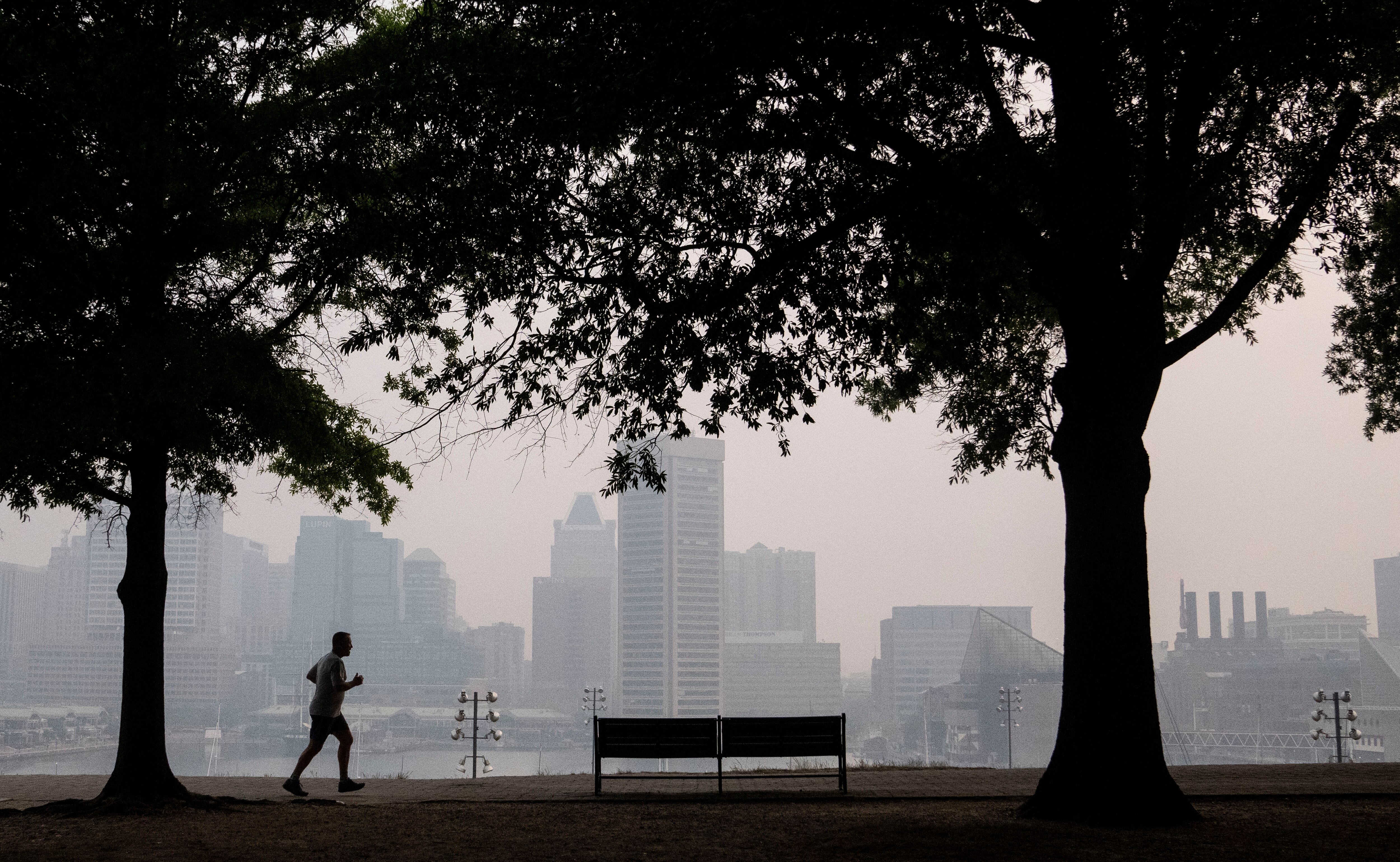 A person runs through Federal Hill Park on Thursday morning, June 8, 2023. Baltimore's air quality remains at dangerous levels due to smoke from Canadian wildfires.