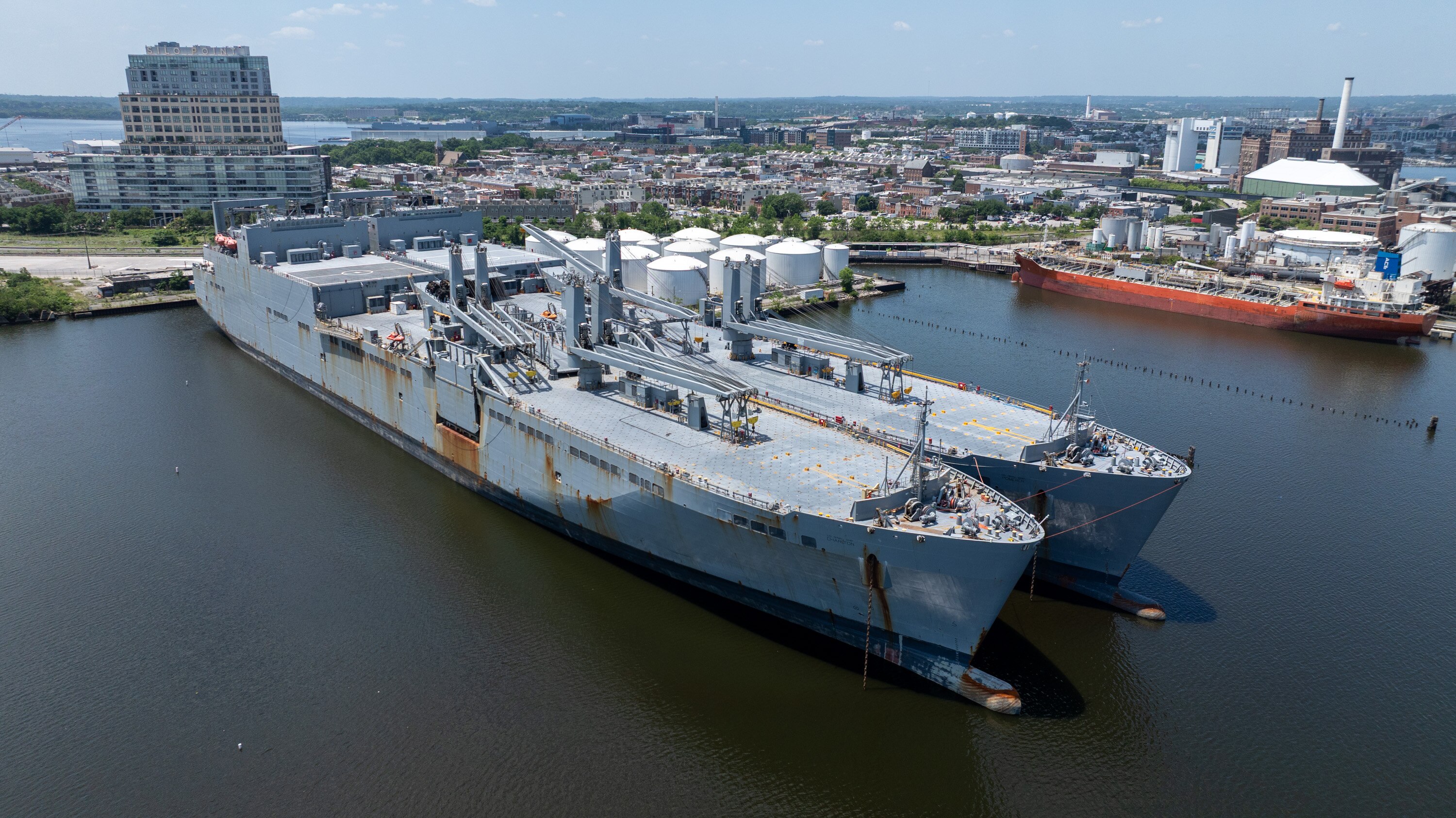A pair of huge Navy ships, the USNS Charlton, left, and the USNS Pomeroy, docked near residential homes at North Locust Point on June 5. Since then, residents say that the ships have never turned off the engines -- meaning that they are always making tons of noise, shining bright lights into people's windows, and making the air all smelly with diesel.