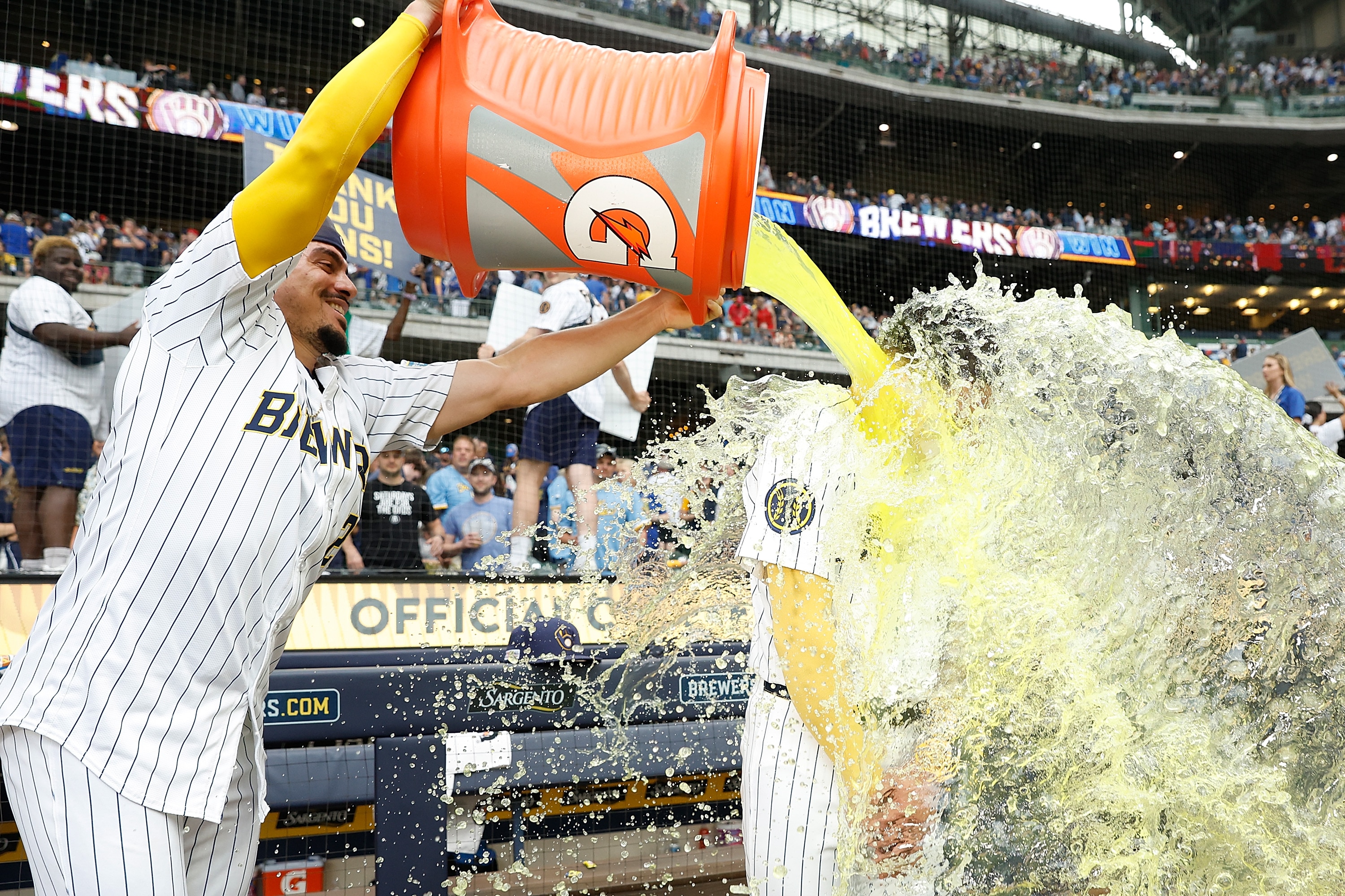 Joey Ortiz, #3 of the Milwaukee Brewers, has Gatorade dumped on him by Willy Adames, #27, after a 3-1 win over the Cincinnati Reds.