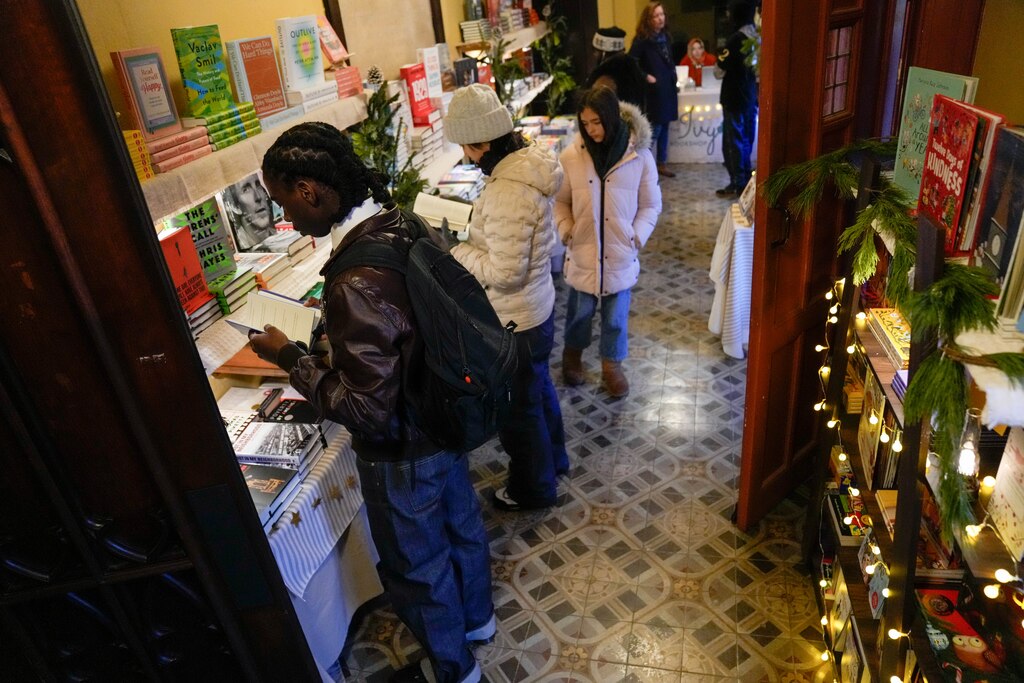 Visitors peruse the books on display during the Ivy Bookshop’s pop-up event inside the Mount Vernon Place United Methodist Church and Asbury House in Baltimore, Md. on Thursday, December 4, 2025.