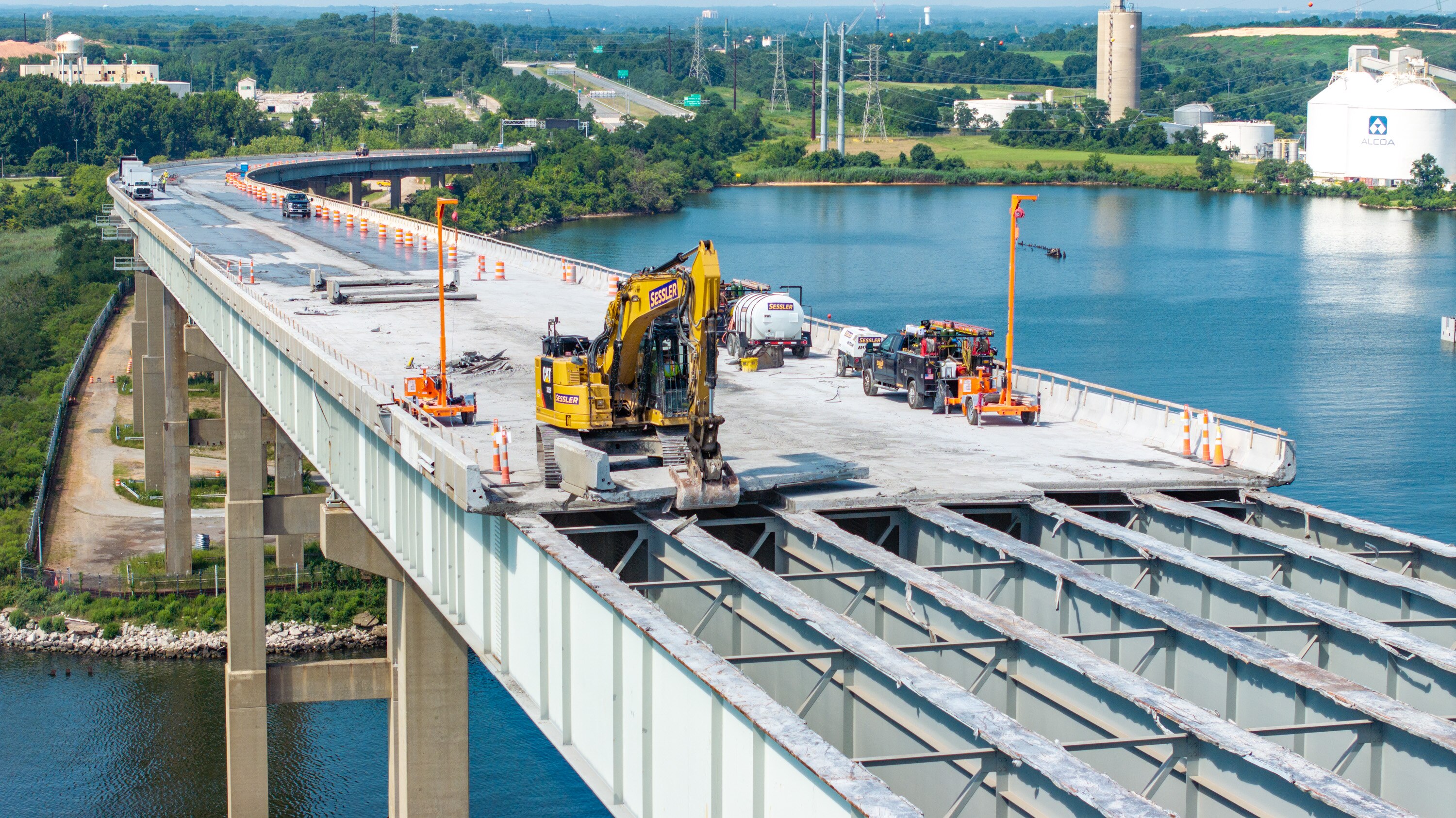 An excavator lifts a slab of roadway as work continued on demolishing the southwest ramp to the Francis Scott Key Bridge on Wednesday.