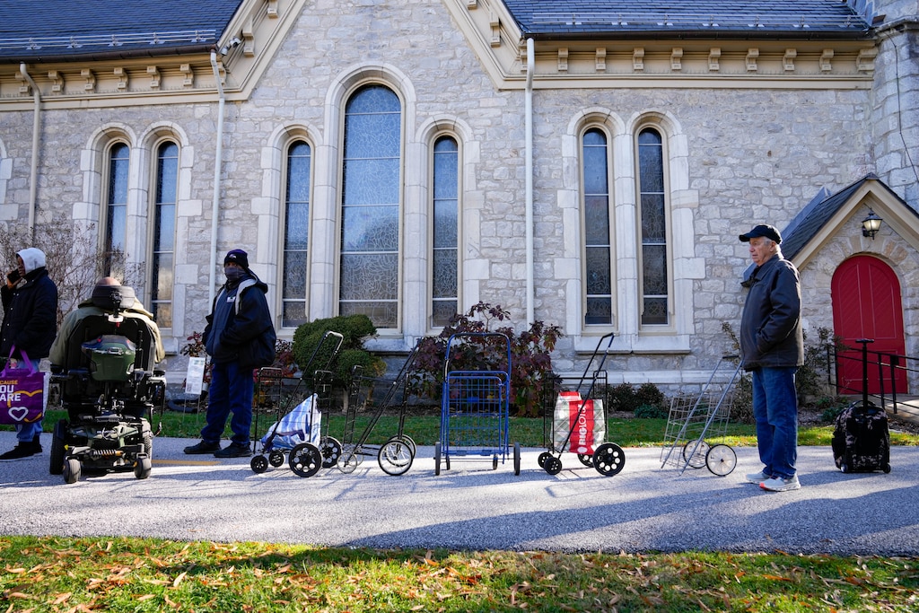 Local residents wait in line ahead of a Thanksgiving holiday meal giveaway at Trinity Episcopal Church in Towson, Md., on Monday, November 24, 2025. The Assistance Center of Towson Churches organized the event, which was also held in 2024.