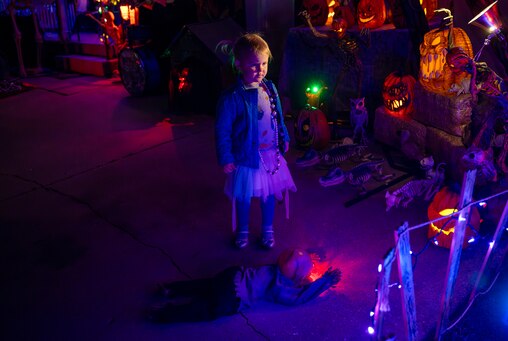 Three year old Maggie MacNeill of North Bethesda is mesmorized by the gory figures of zombies, haunted pumpkins and a crawling devilish baby figurine that adorn the Agouridis family haunted house in Silver Spring.