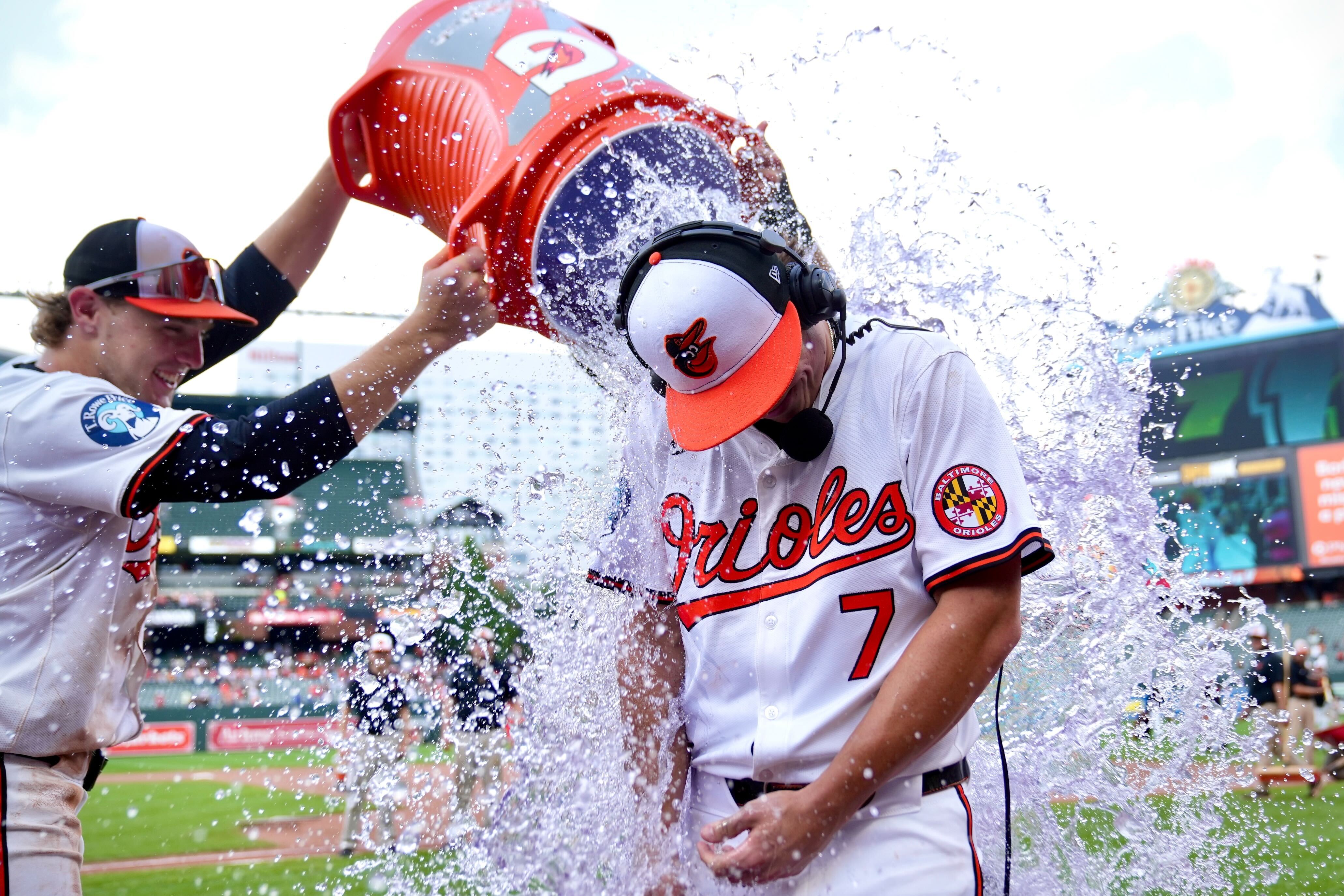 Orioles players Gunnar Henderson, left) and Colton Cowser dump a cooler of Gatorade on Jackson Holliday after the rookie hit his first career home run, a grand slam, against the Toronto Blue Jays.