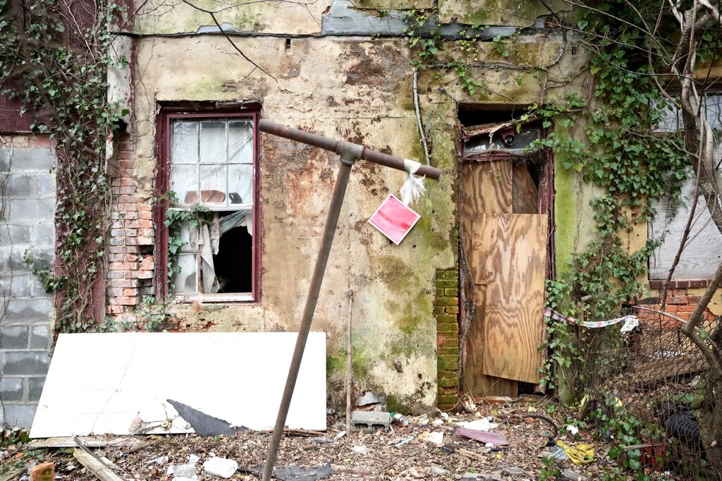 Mayor Brandon Scott speaks outside of vacant homes on West Saratoga street during a press conference hosted by Build One Baltimore on February 16, 2023.