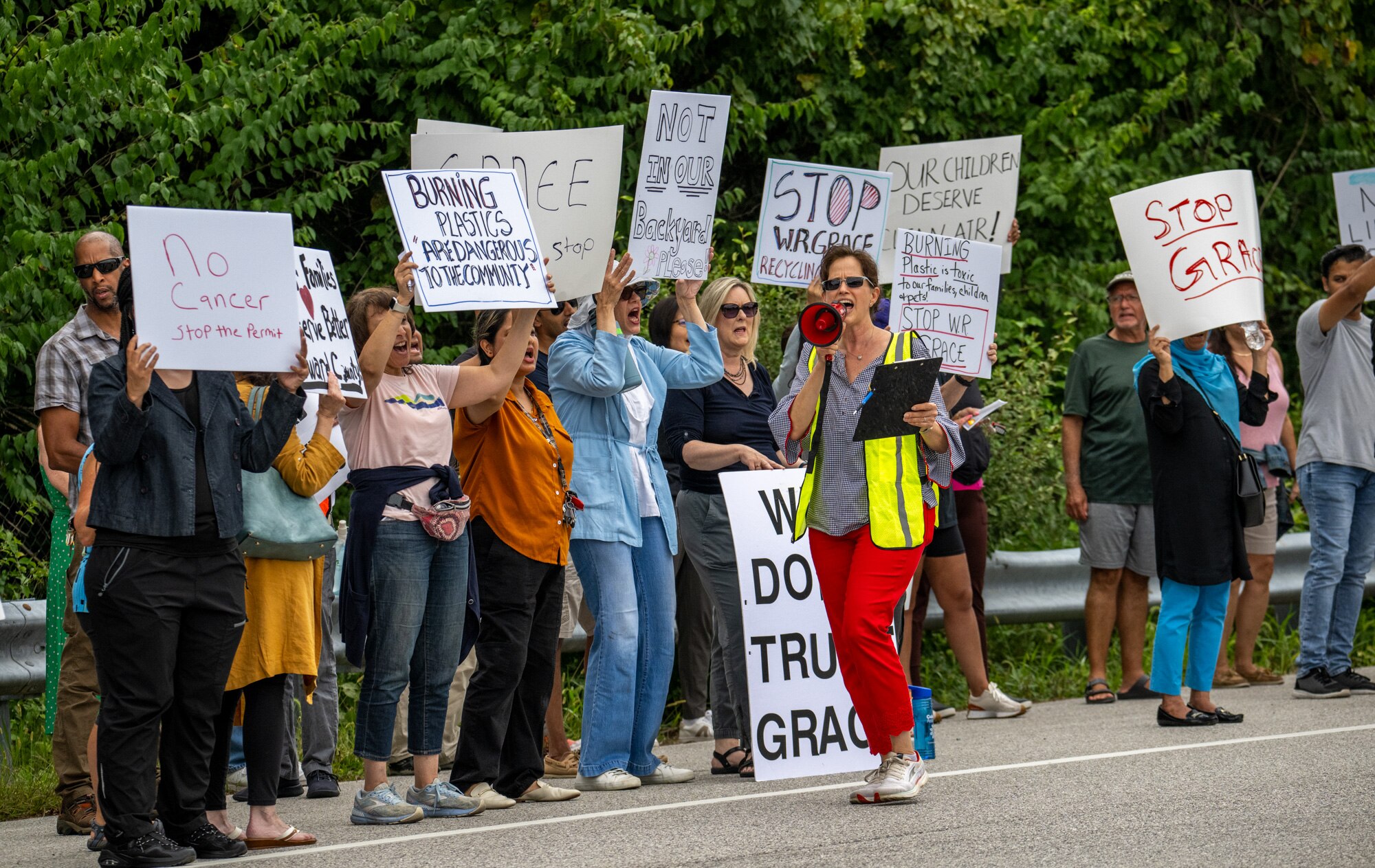Protesters stand outside the W.R. Grace & Co. headquarters in Columbia on Friday, Sept. 6, 2024. Residents are protesting the company’s plan to build a pilot plastics recycling plant close to their homes.