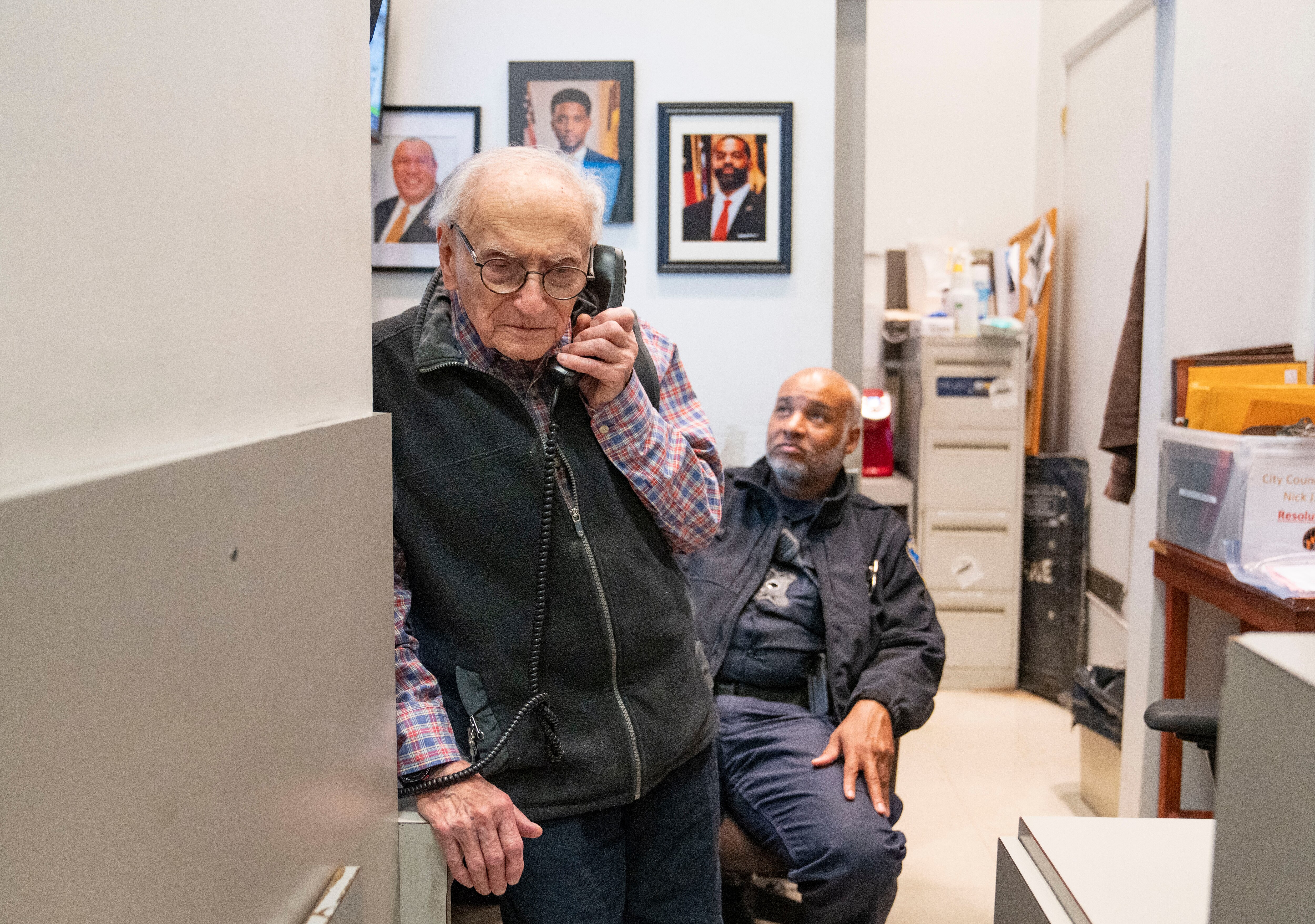 Sid Grossman, City Hall’s 90-year-old greeter, talks on the phone to government officials in Baltimore on Tuesday, Nov. 21, 2023.