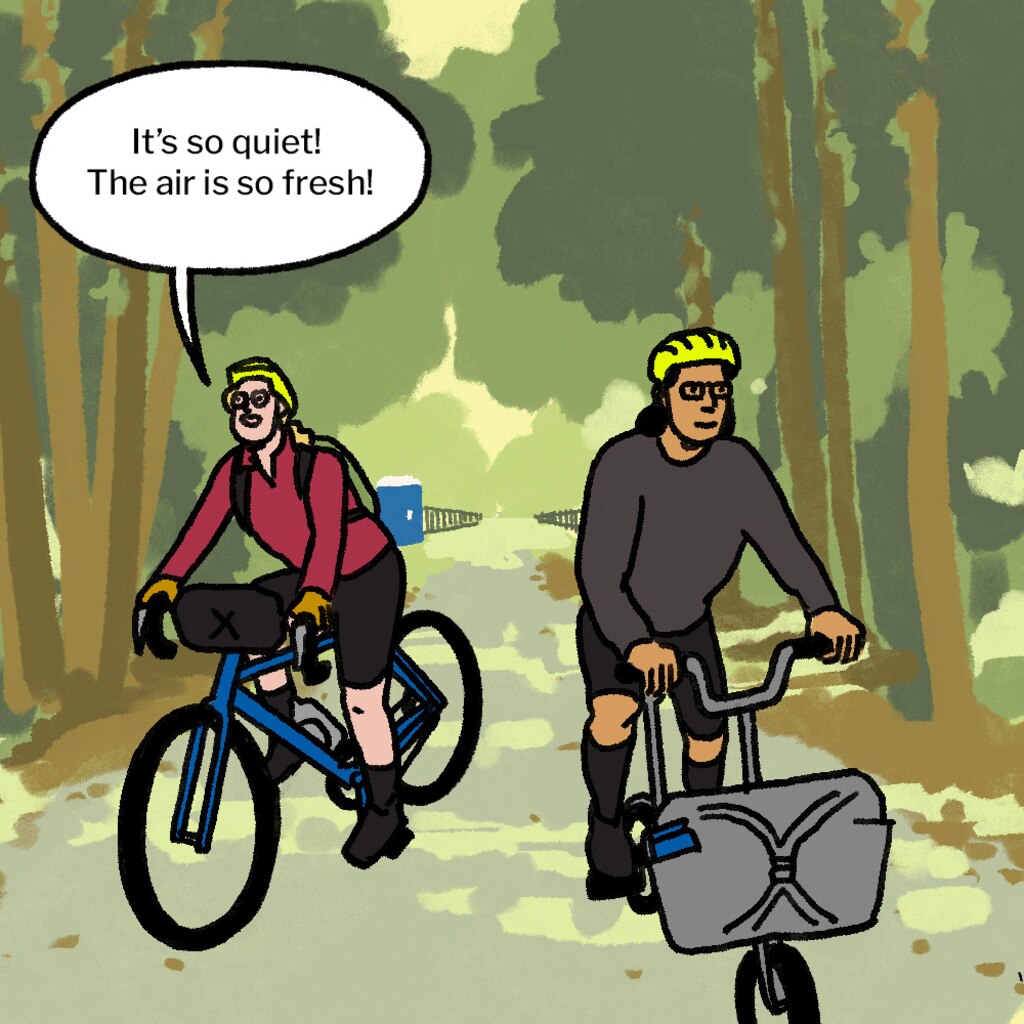 Illustration of man and woman, seen from behind, on bikes in parking lot in front of the beginning of a trail that leads into the forest. A brown sign says "Northern Central Railroad Trail." Man looks back at woman and says: "That was rough." Woman says: "Well, I'm glad we're here now."