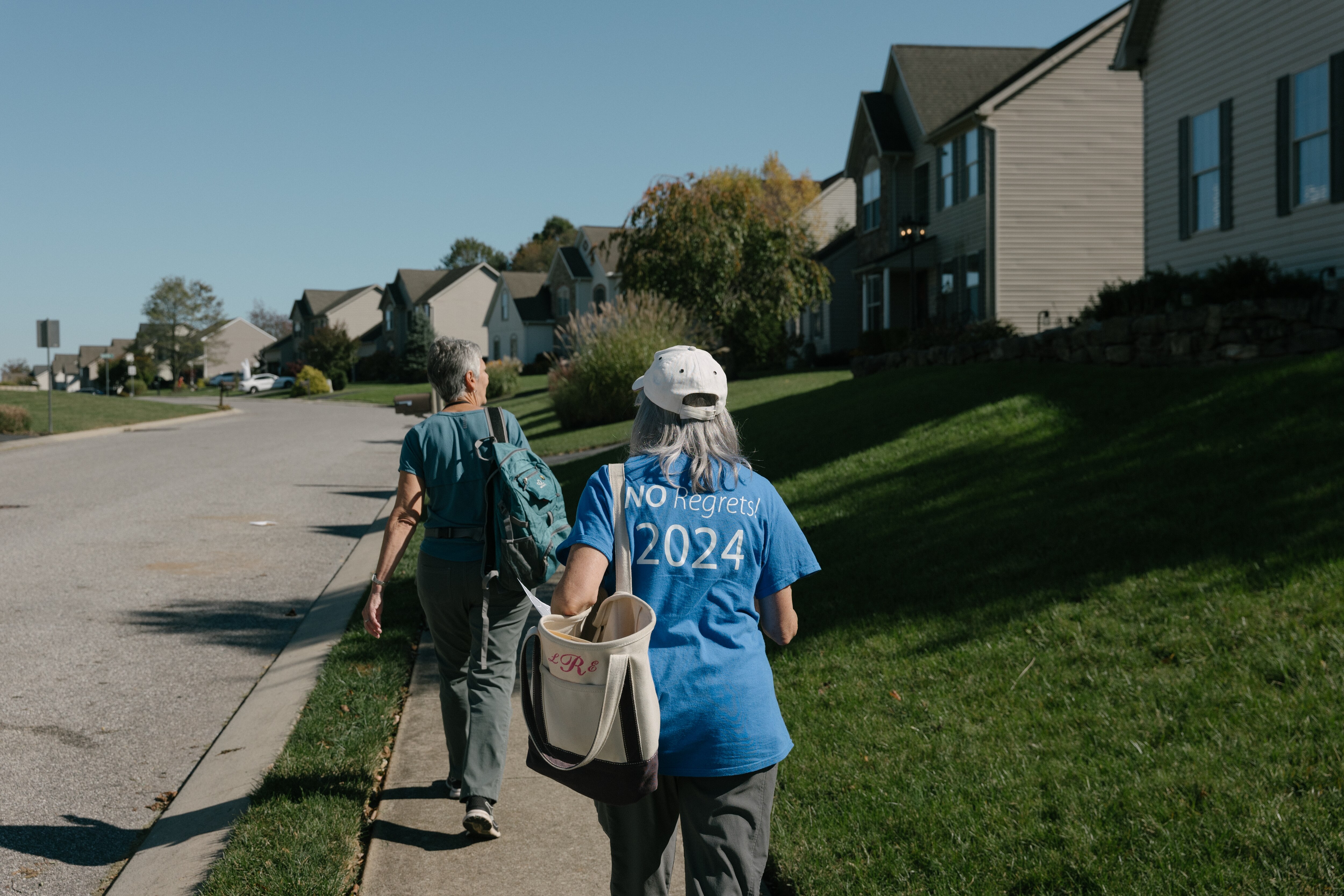 Malissa Ruffner and Liz Entwisle walk through a neighborhood while canvassing for Democrats in York, Pennsylvania, on October 20, 2024. Ruffner and Entwisle are volunteer canvassers with Allies from Democracy.