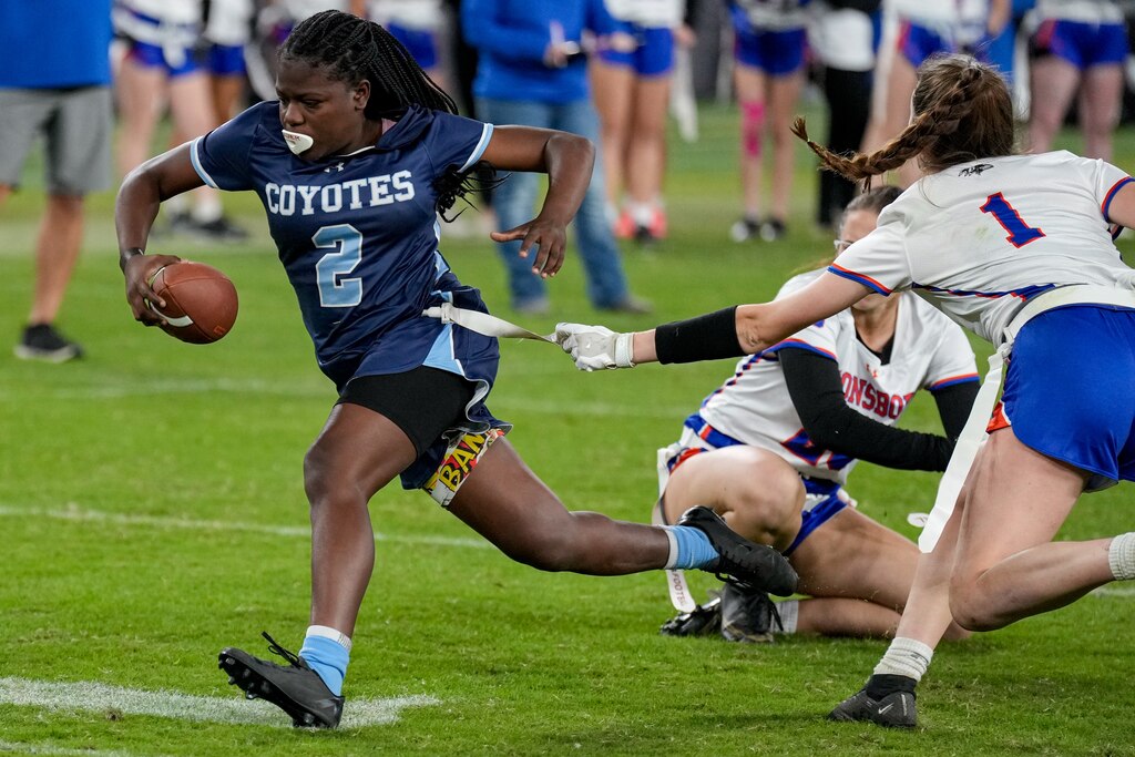 Boonsboro’s Annabel Fletcher (1) grabs the flag of Clarksburg’s Aysia Jones Robinson (2) during the 2024 Maryland High School Girls Flag Football Championship.