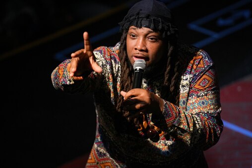 Host Kenneth Something speaks with audience members in between performances during the Charm City Slam Finals at the Chesapeake Shakespeare Company in Baltimore, Md. on Tuesday, July 22, 2025.