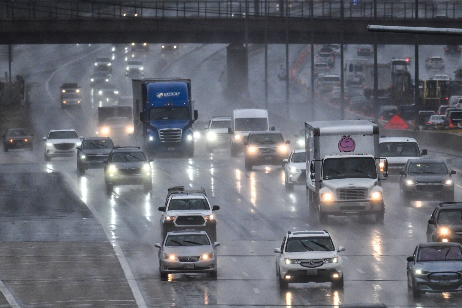Traffic travels on the outer loop of I-695 at Falls Road as rain falls on the region.