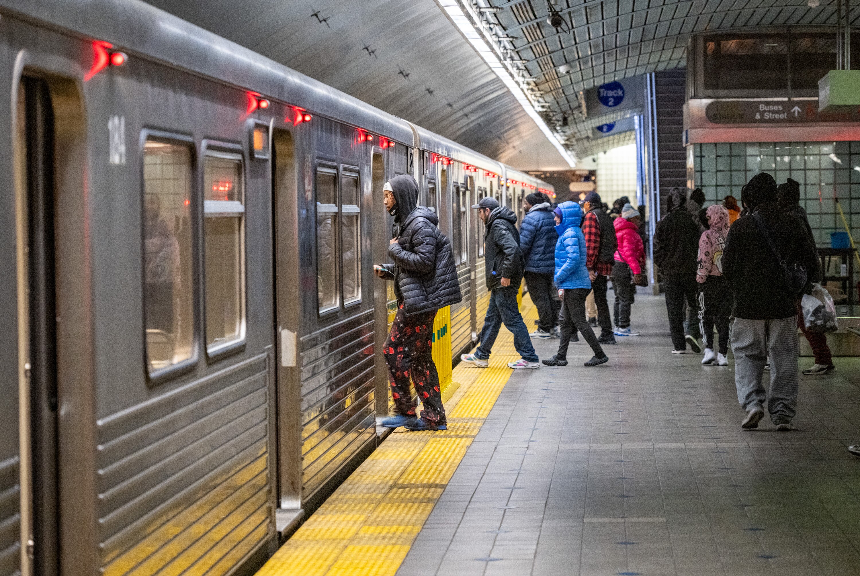 Passengers board an MTA Metro SubwayLink train in the Johns Hopkins Station. 