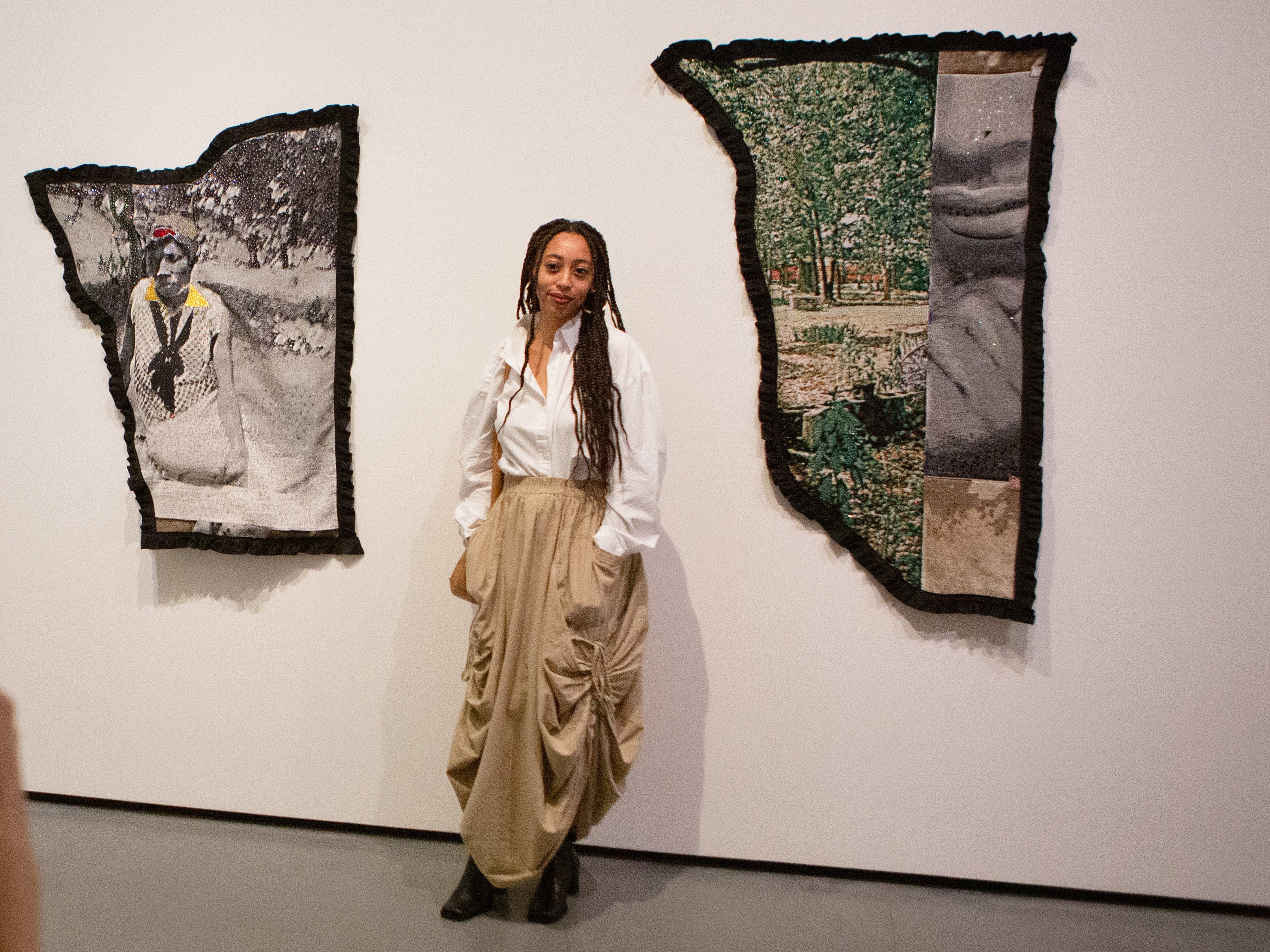 Artist Akea Brionne poses with her work, "An Ode to (You)'all," at the unveiling ofBaltimore Museum of Art's exhibition, "A Movement in Every Direction: Legacies of the Great Migration". Brionne is one of twelve newly commissioned artists featured in the exhibition, which aims to showcase the personal stories and widespread impact of the Great Migration.