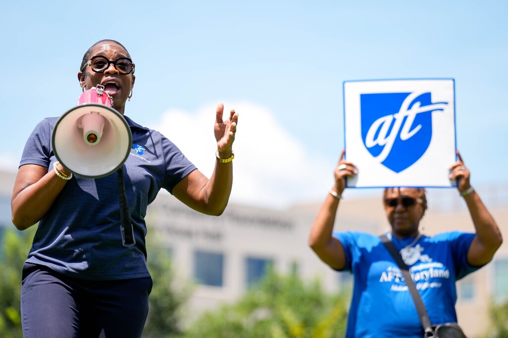 Kenya Campbell, president of Maryland’s branch of the American Federation of Teachers, gives remarks through a megaphone to a crowd during a rally to support Howard Community College faculty on the school’s quad in Columbia, Md. on Monday, July 28, 2025.