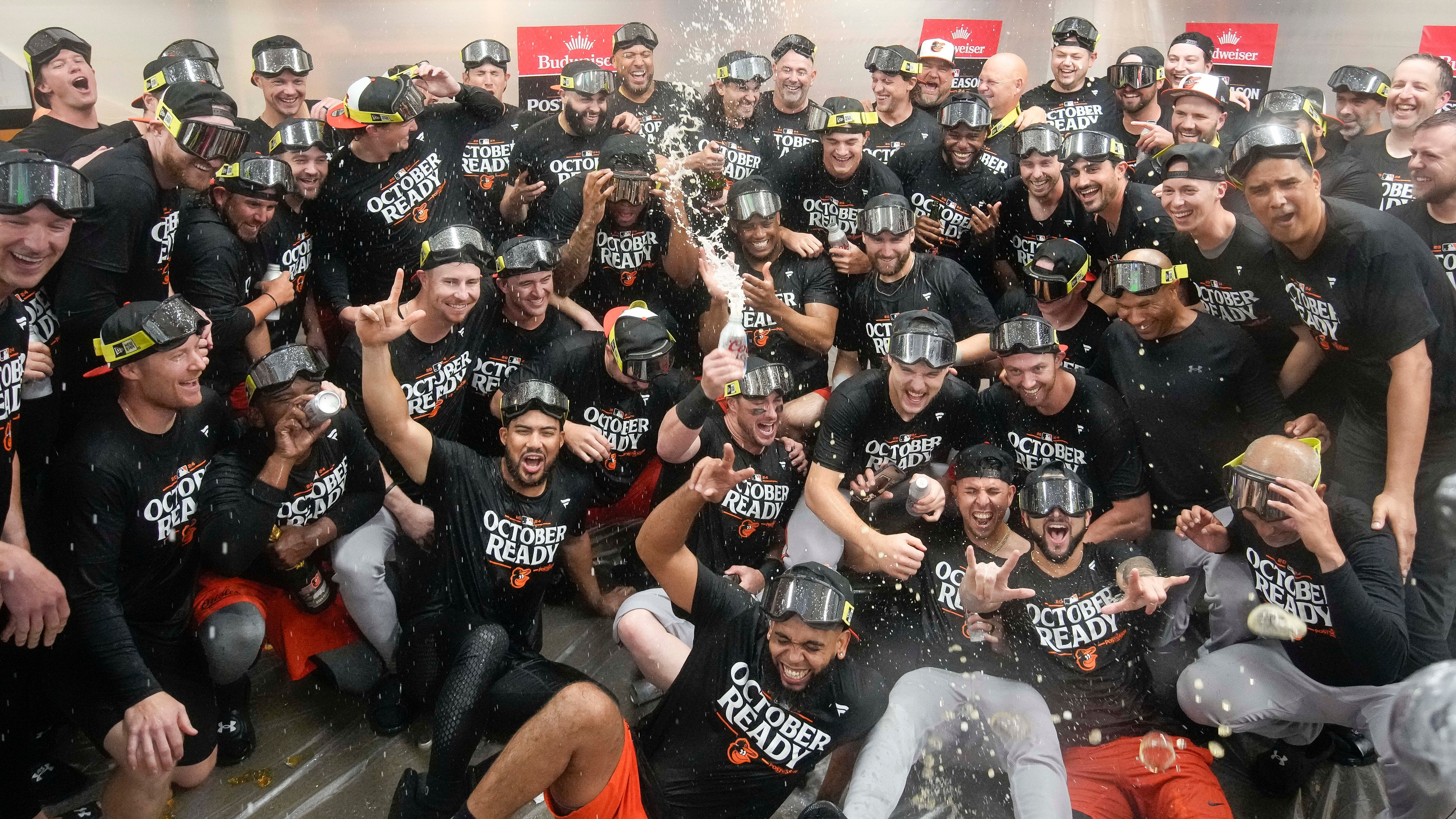 Baltimore Orioles' players celebrate after clinching a playoff berth by defeating the New York Yankees in baseball game, Tuesday, Sept. 24, 2024, in New York. (AP Photo/Bryan Woolston)