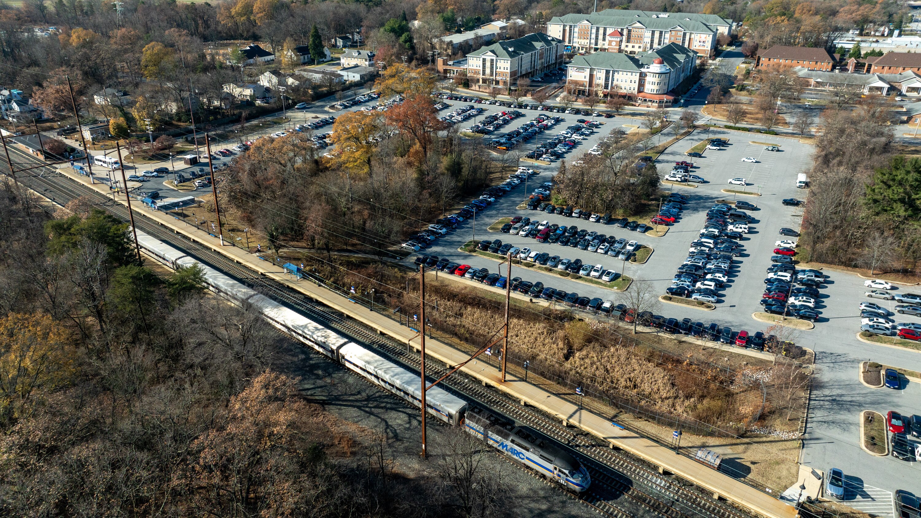 A northbound MARC train pulls away from the station in Odenton. The northwest parking lot of the station is slated for redevelopment.