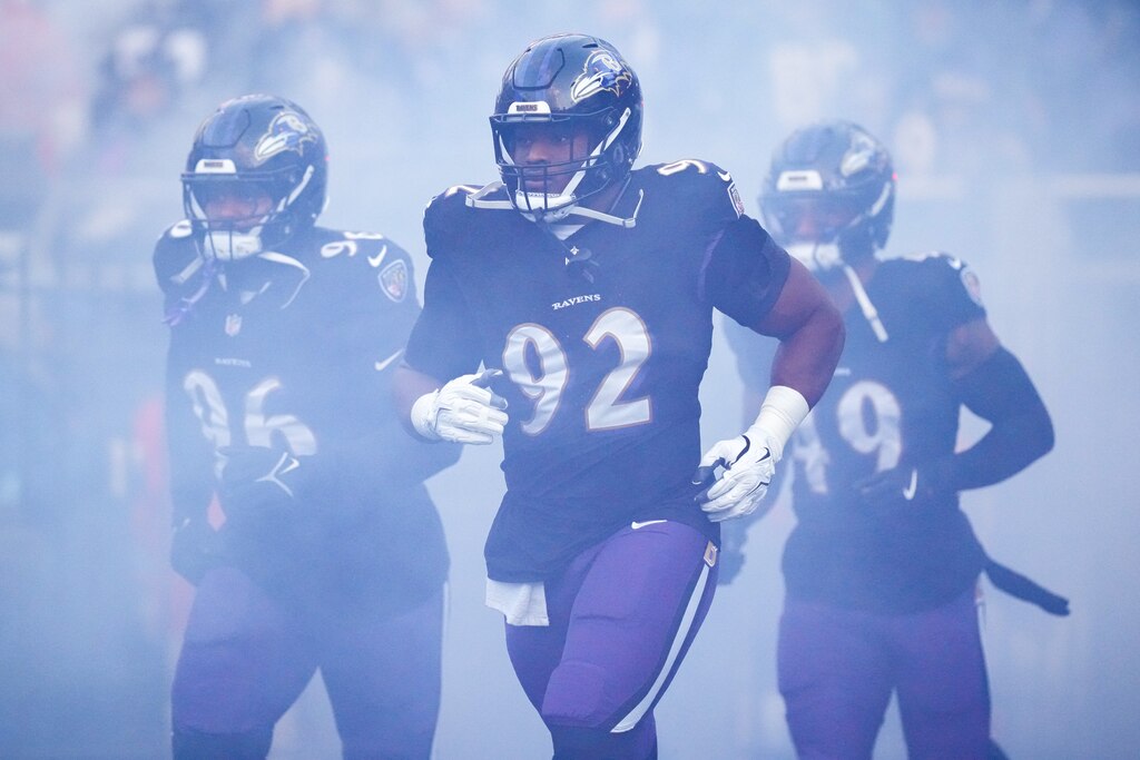 Baltimore Ravens defensive tackle Nnamdi Madubuike (92) runs out of the tunnel with his teammates before a game against the Philadelphia Eagles at M&T Bank Stadium in Baltimore, Md. on Sunday, December 1, 2024.
