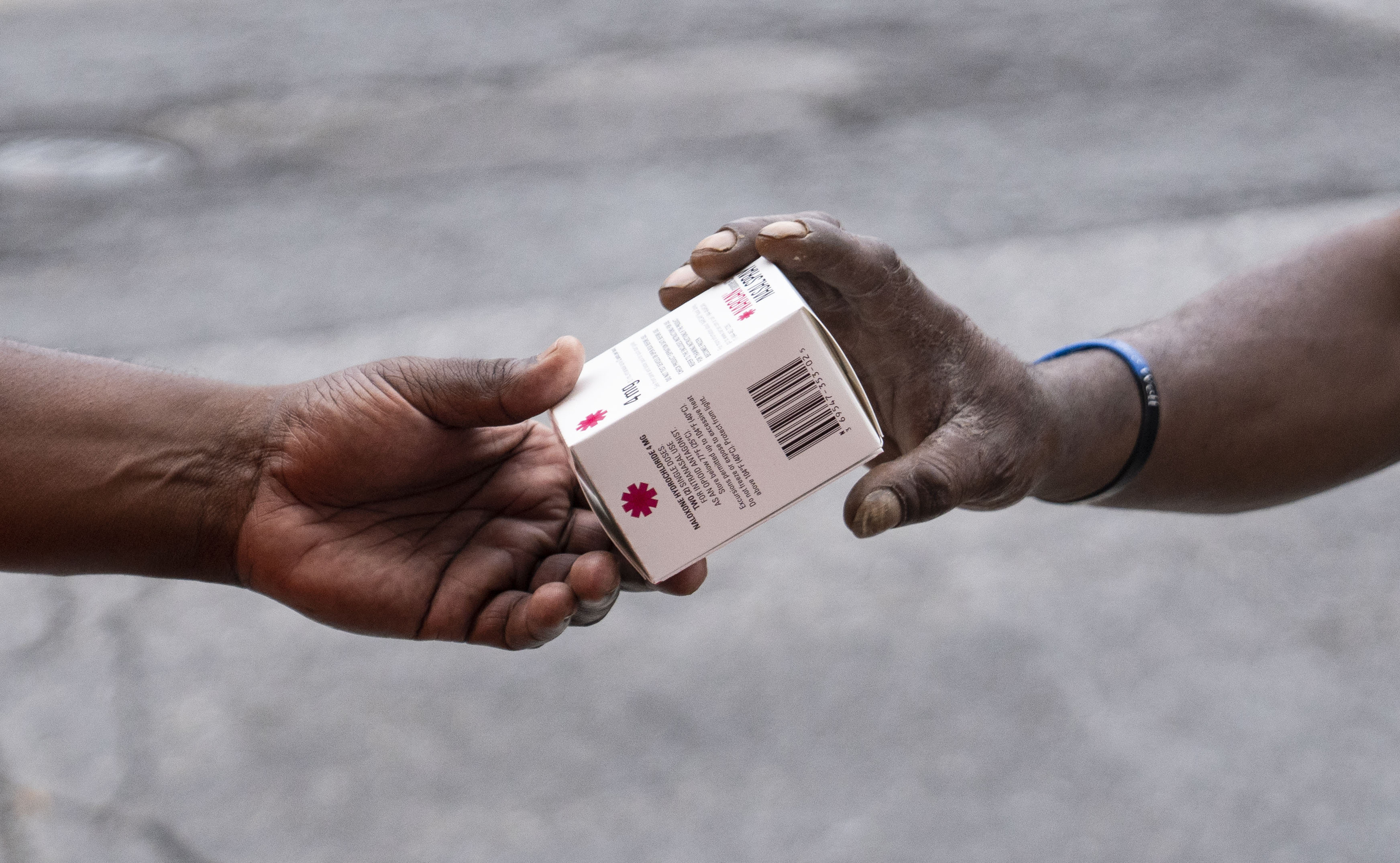 A Bmore POWER worker distributes Narcan at an intersection of Cumberland Street and Pennsylvania Avenue in Baltimore on Thursday, August 3, 2023.