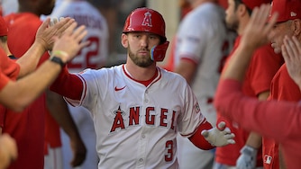 Los Angeles outfielder Taylor Ward is greeted in the dugout after scoring a run during the first inning against the Minnesota Twins on Sept. 9.