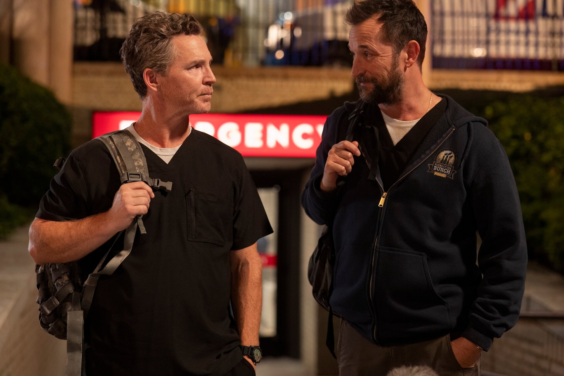 Drs. Jack Abbott (Shawn Hatosy, left) and Michael "Robby" Robinavitch (Noah Wyle) exit the Pittsburgh Trauma Medical Center on an episode of "The Pitt."