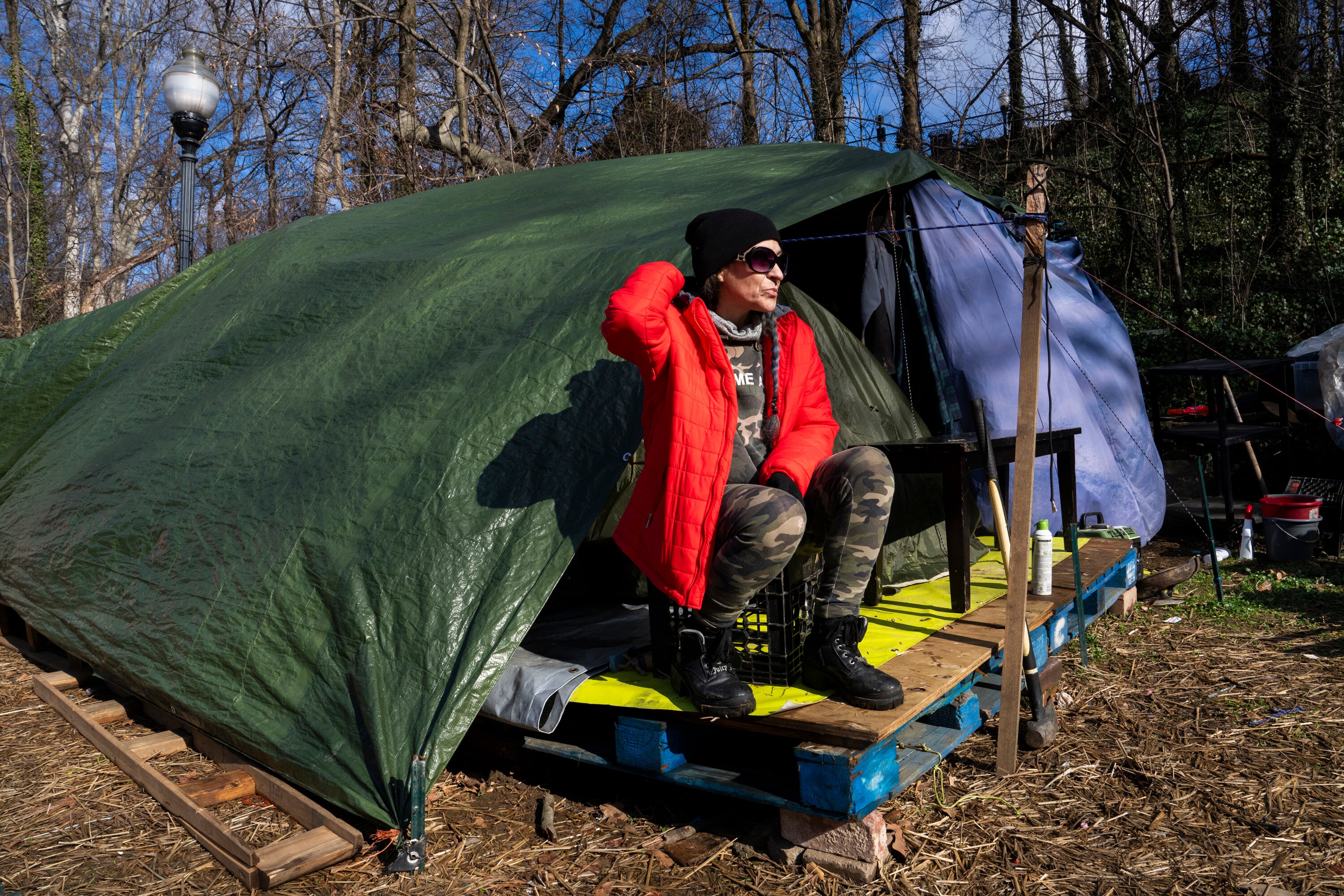 Stephanie Lovelace and her partner have lived in a tent in Wyman Park Dell since the summer. They along with several others in a rotating homeless encampment are going to have to leave the park as the city gradually clears it this month. She is pictured here on Feb. 13, 2024.