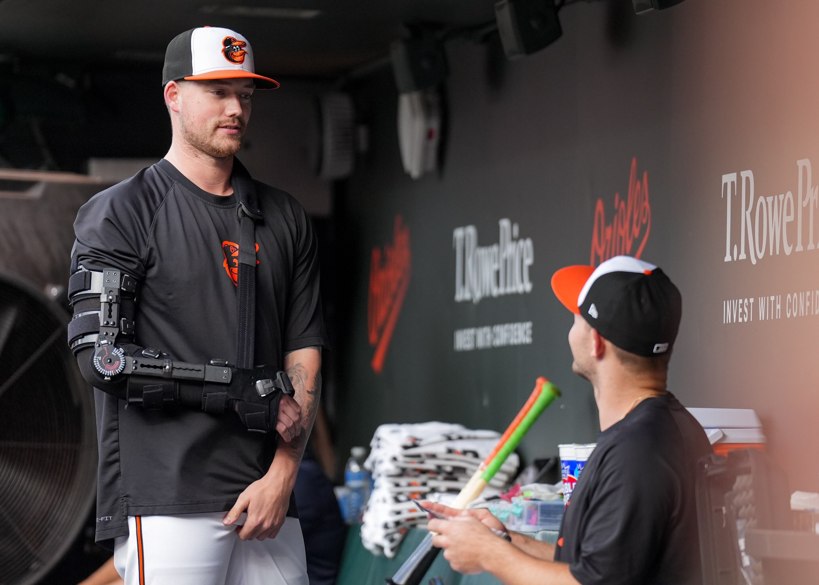 Kyle Bradish, with his arm in a brace after Tommy John surgery, is one of seven key pitchers to miss time for the Orioles this year.