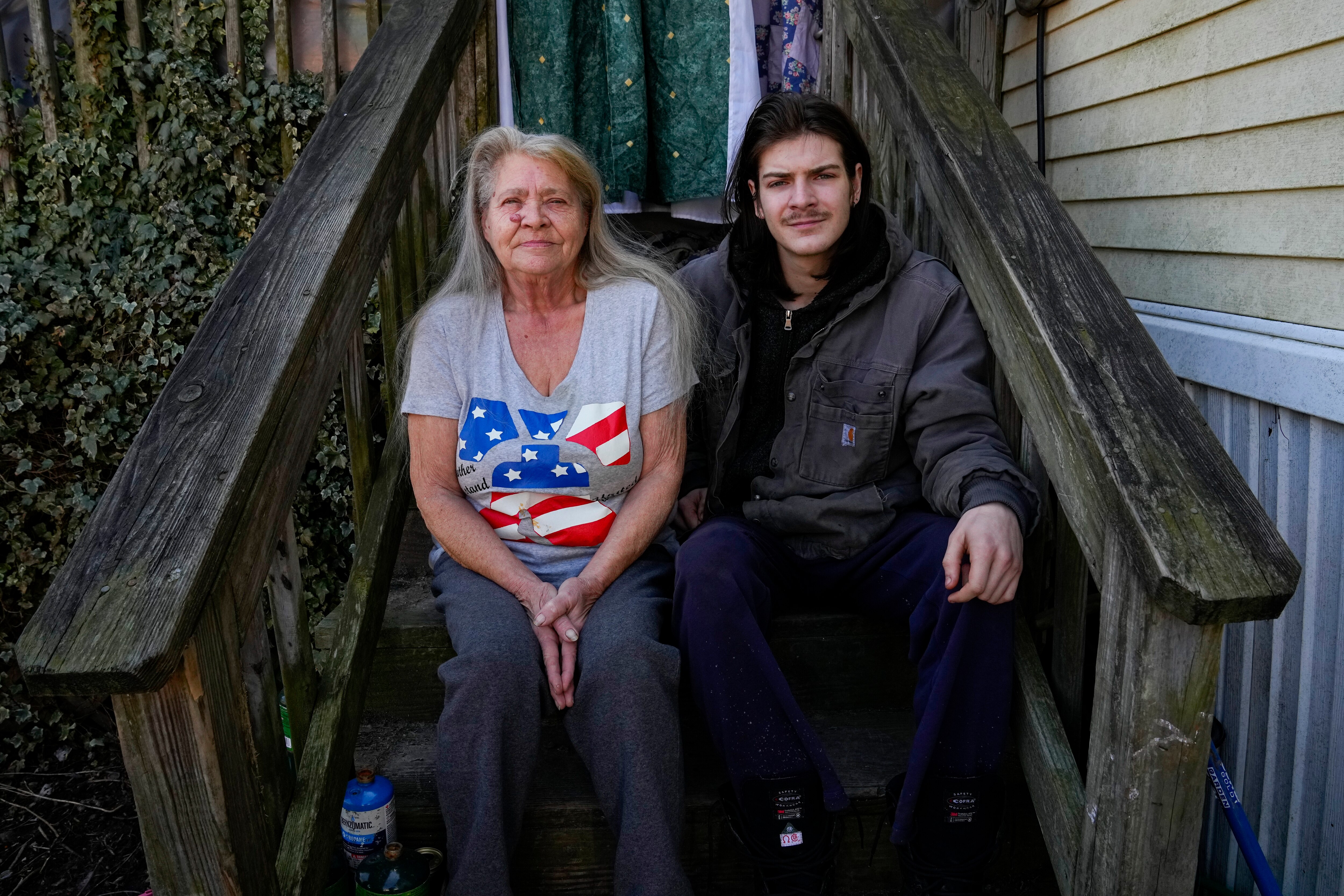 Lanette Clendaniel, left, mother of Sarah Beth Clendaniel, and her grandson Daniel Clites, 20, nephew of Sarah Beth Clendaniel, pose for a photograph for The Associated Press outside her home, Wednesday, Feb. 8, 2023, in North East, Md. U.S. Attorneys for Maryland announced the arrests and a federal criminal complaint charging Sarah Beth Clendaniel, of Catonsville, and Brandon Clint Russell, of Orlando, with conspiracy to destroy an energy facility.